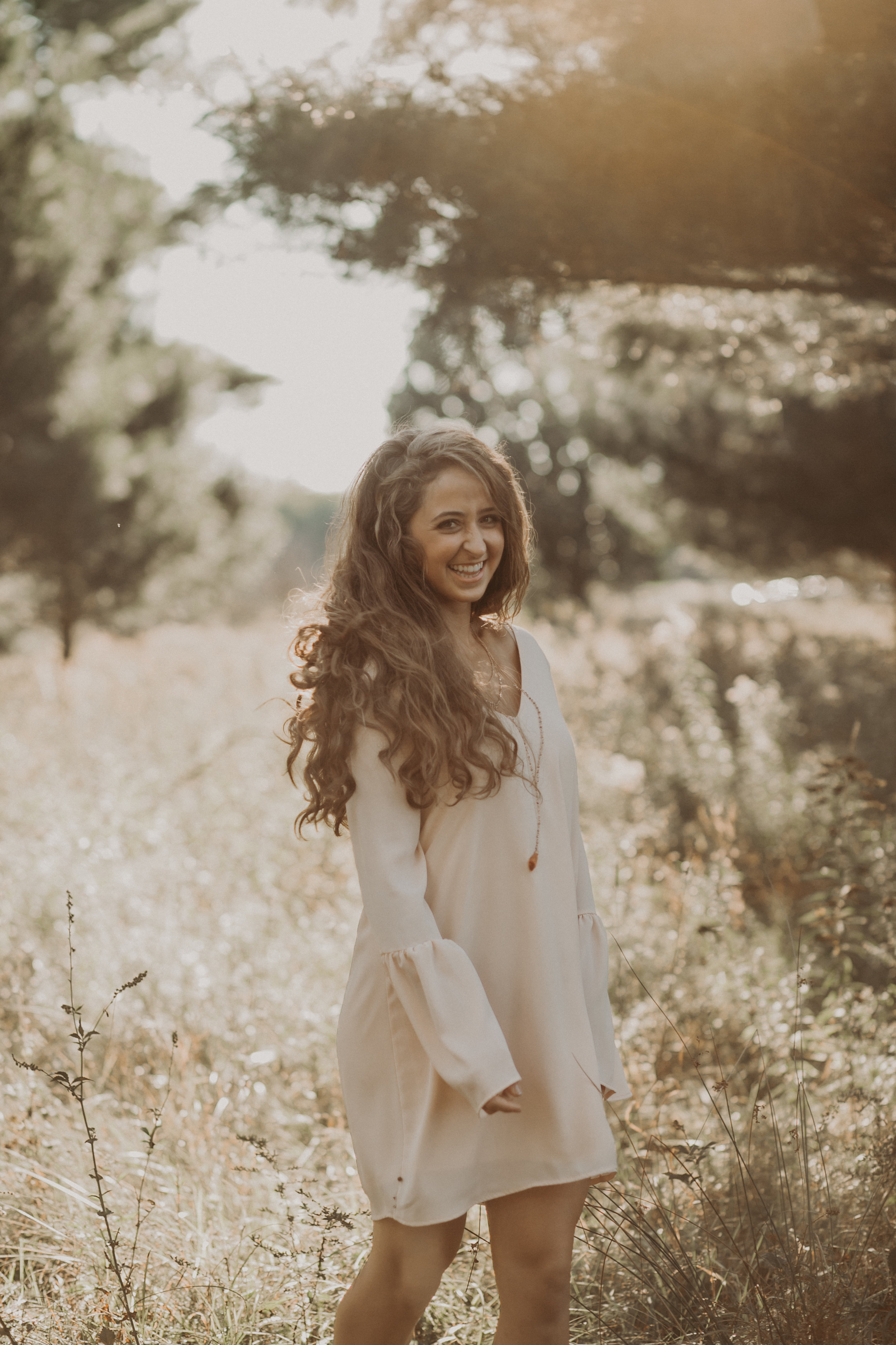 Marshfield High school senior Dara spins in the field lit by sunset