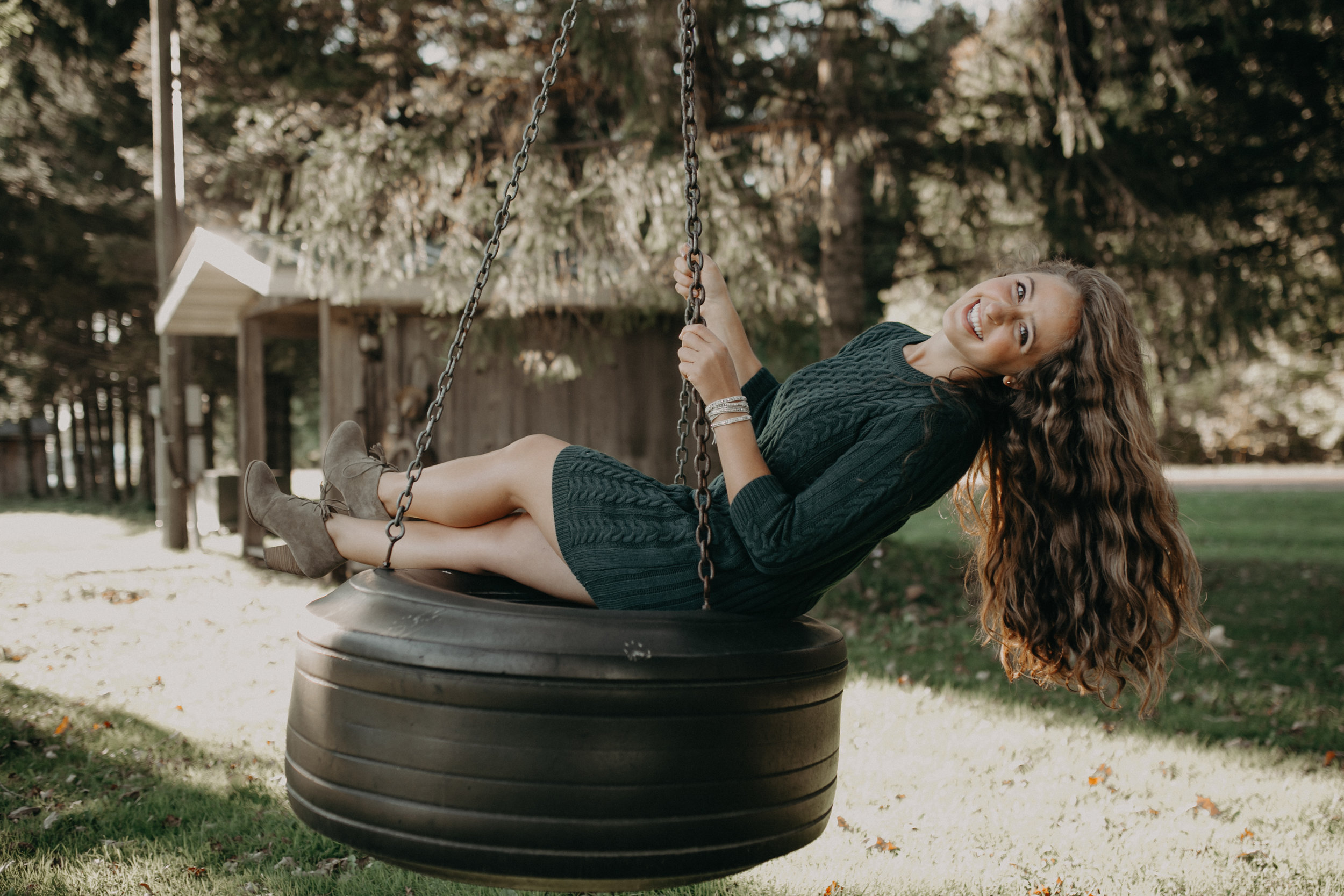 high school senior Dara Stichert swings on a tire swing on Stichert Farms