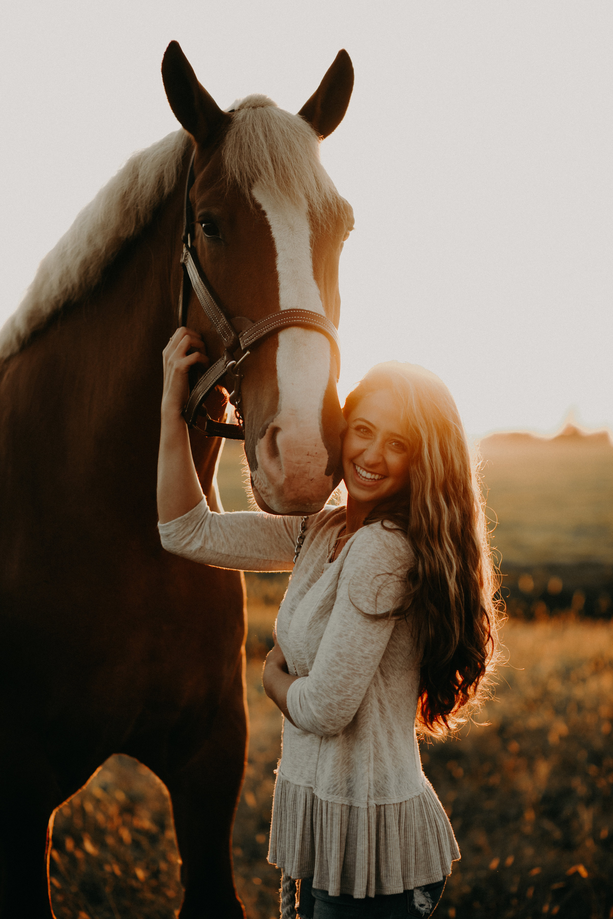 Dara poses with her horse during equestrian senior photo session in Chili WI at Stichert Farms
