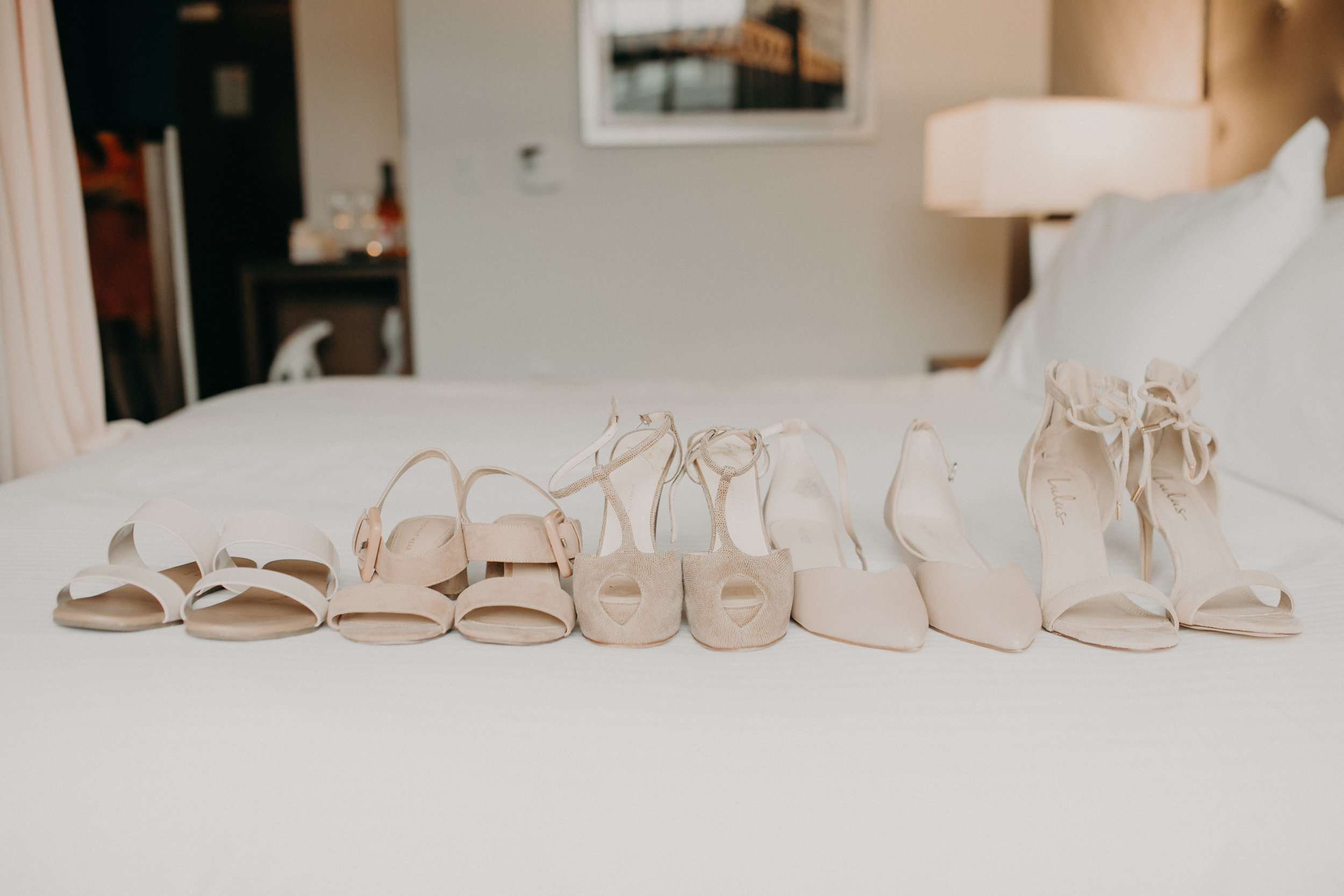  wedding shoes on the hotel bed in Wayzata MN Hotel Landing 