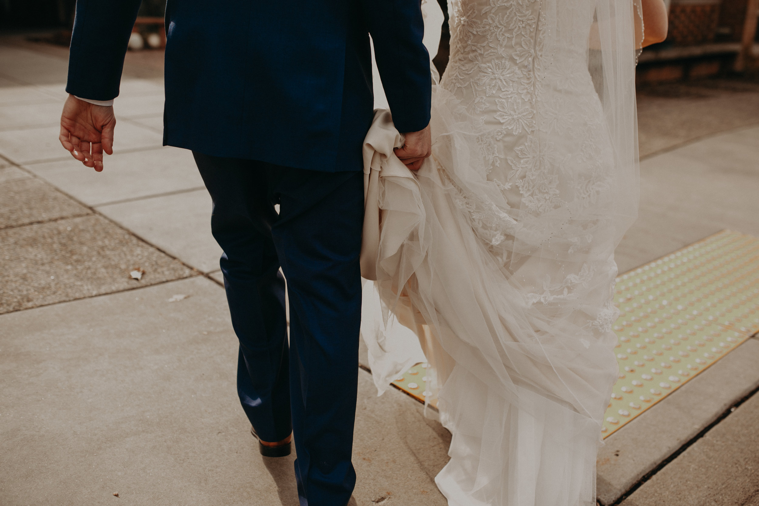 groom-carrying-wedding-dress-river-falls