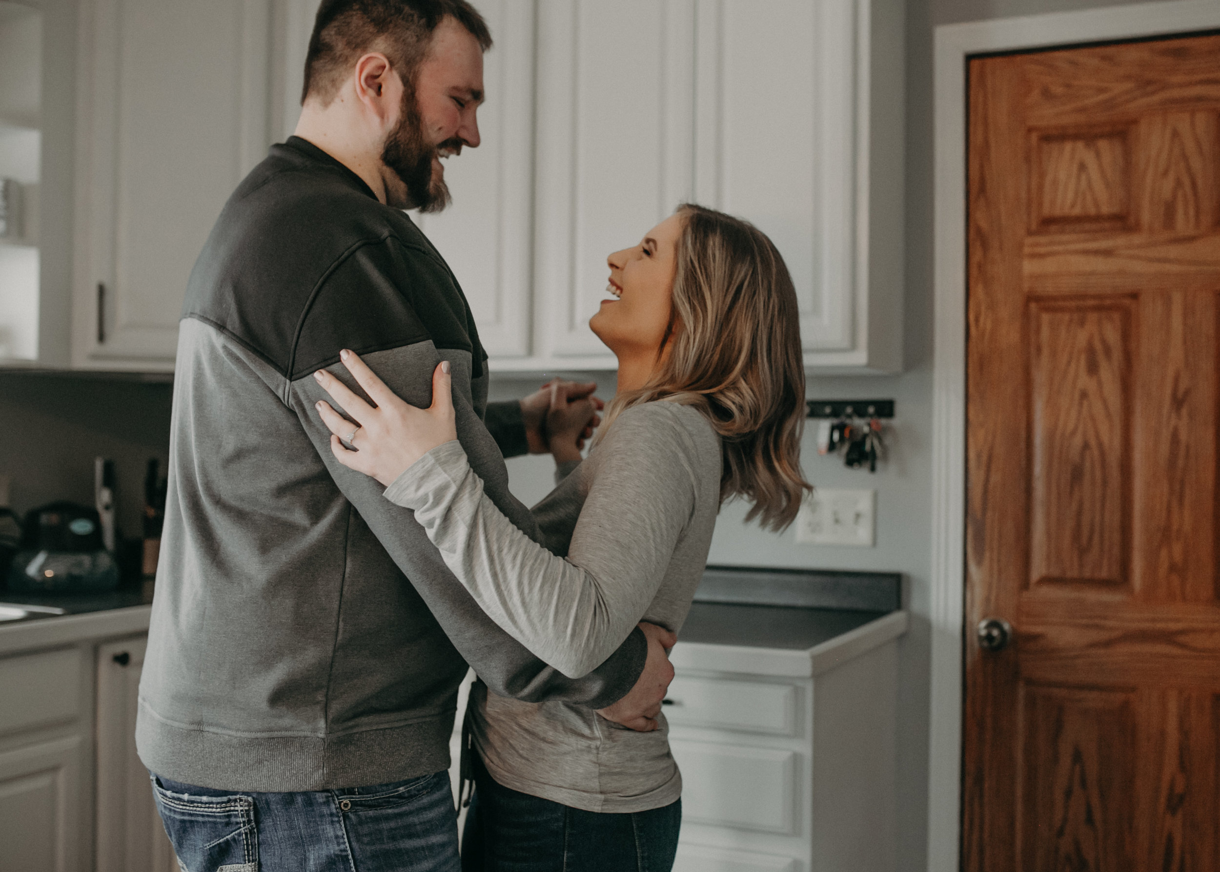 photos of a couple dancing in their kitchen by engagement photographer Andrea Wagner in Athens WI