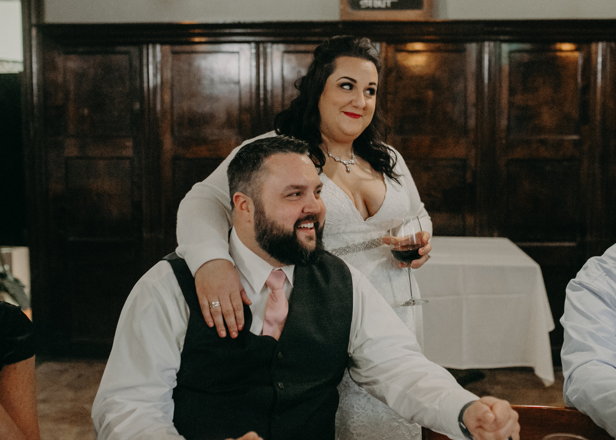 A happy wedding couple enjoys dinner and drinks at Sweeney’s Saloon in St Paul MN