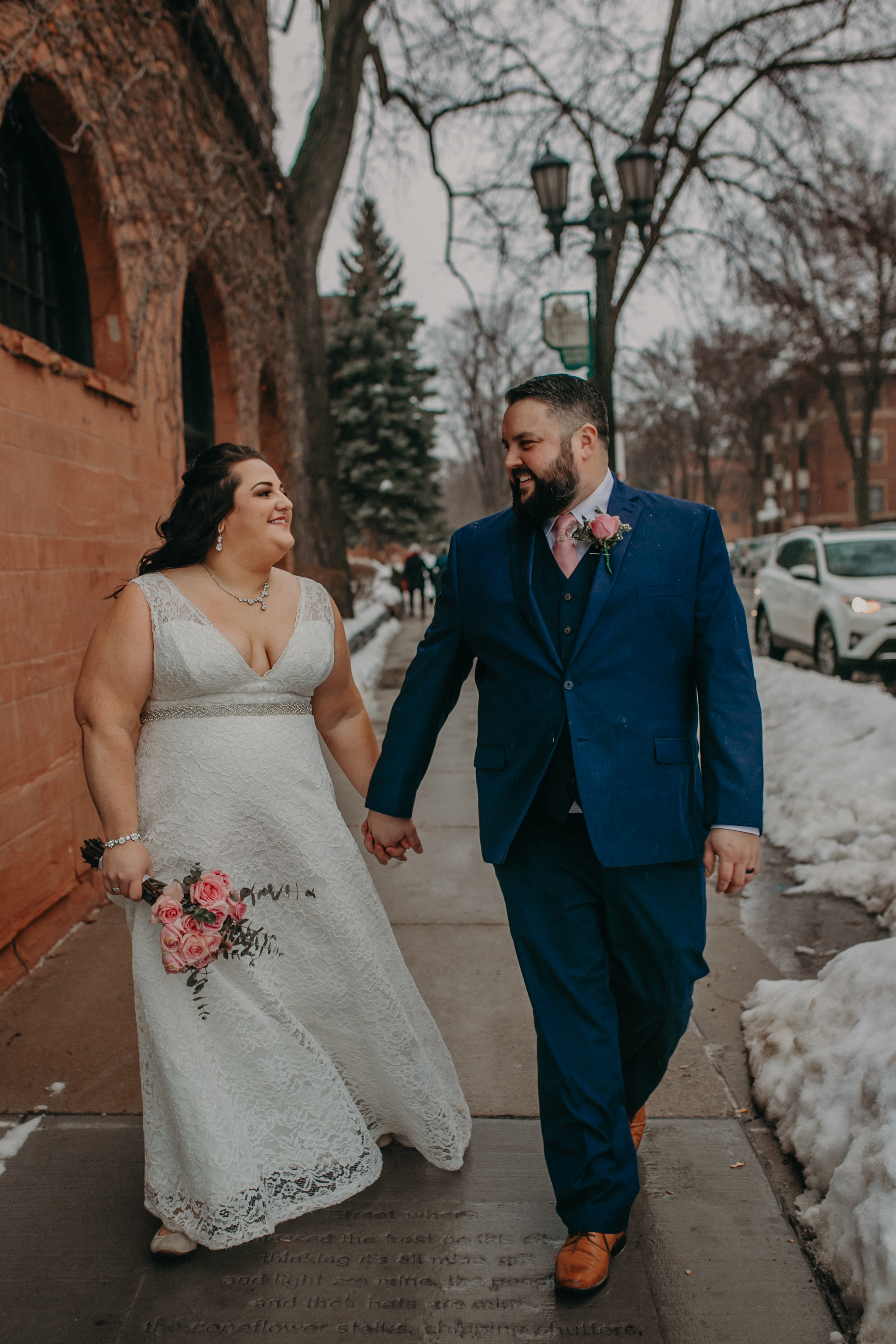A couple just married stroll along the sidewalk near W.A. Frost on Historic Cathedral Hill in St Paul MN