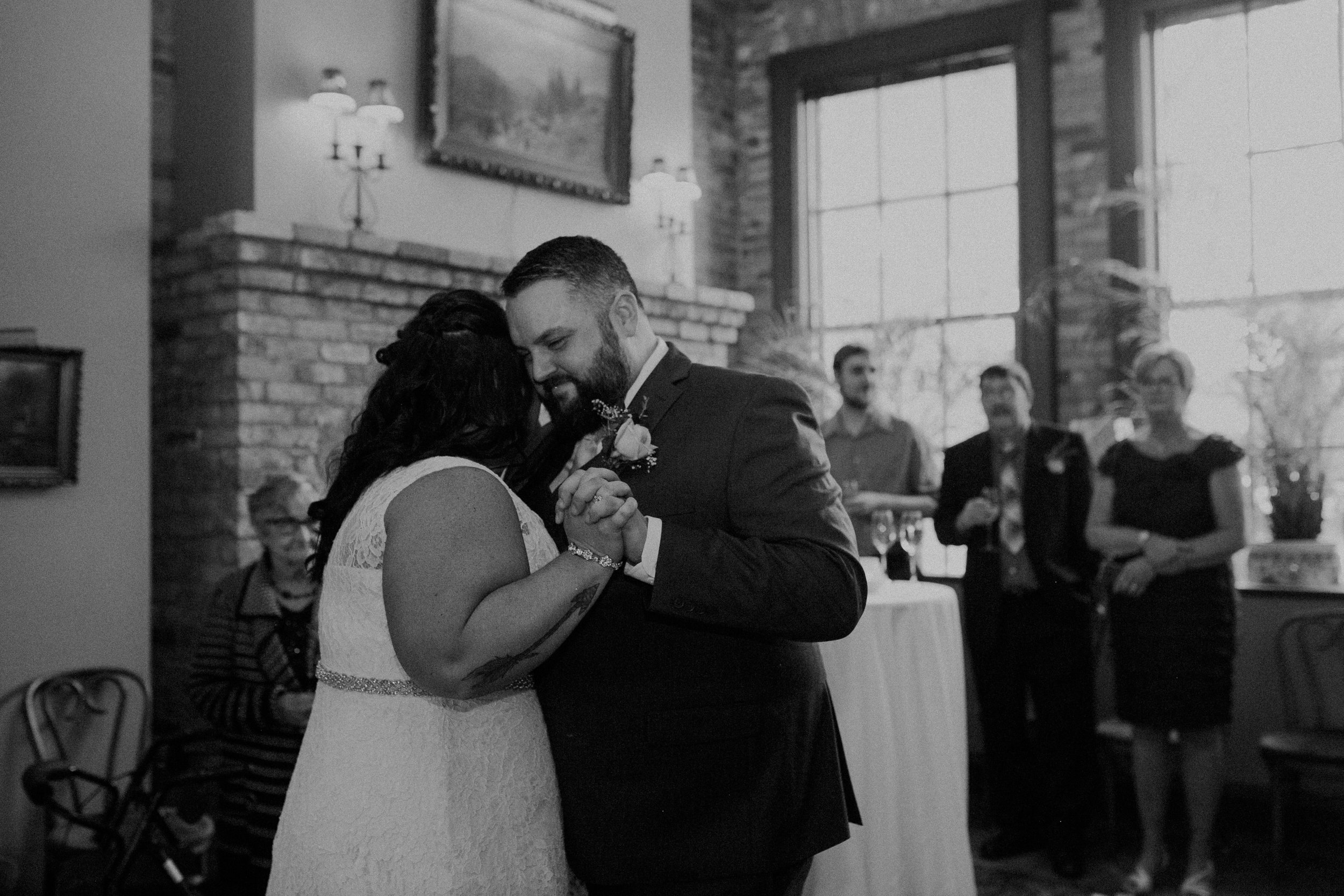 A couple enjoys their first dance in the Fireside Room of W.A. Frost after their wedding ceremony