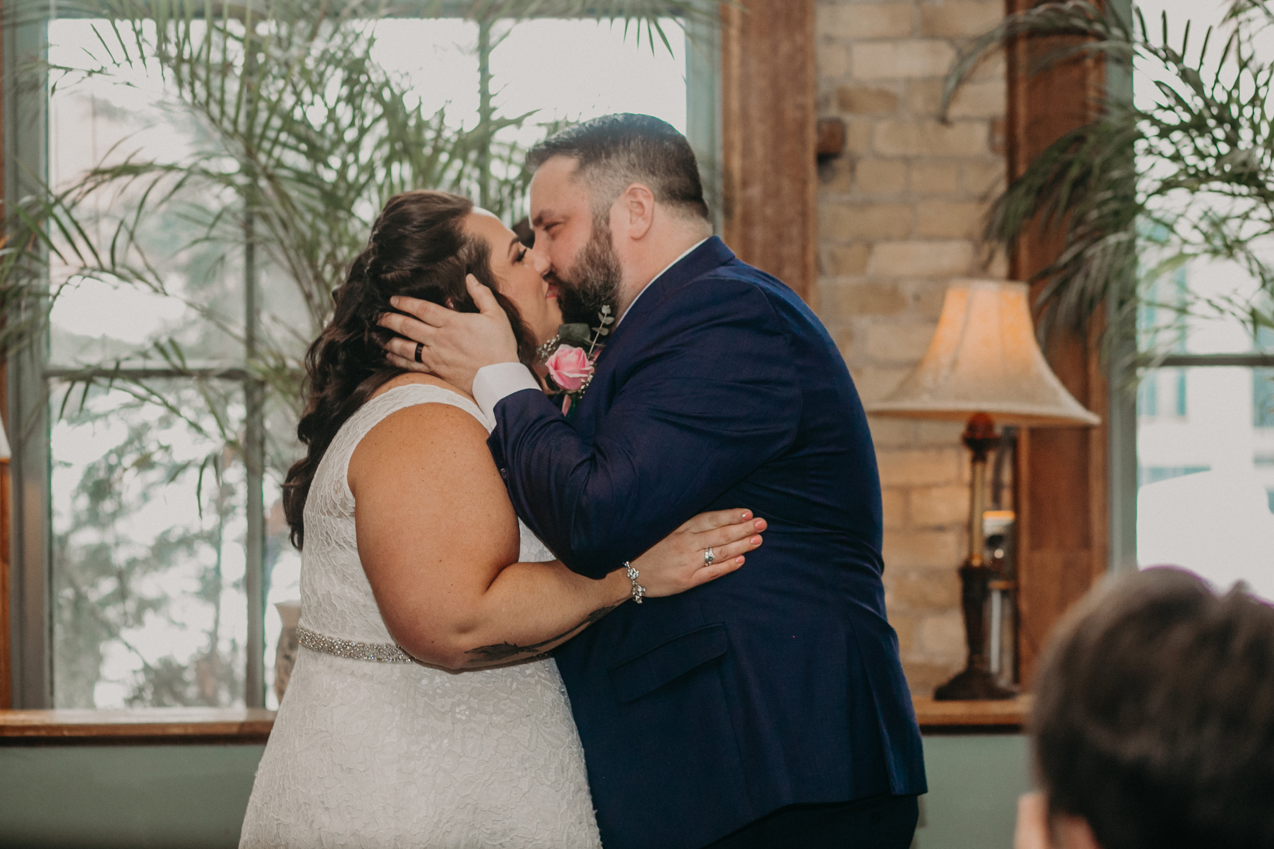 A bride and groom enjoy their first kiss as husband and wife at W. A. Frost in St Paul MN
