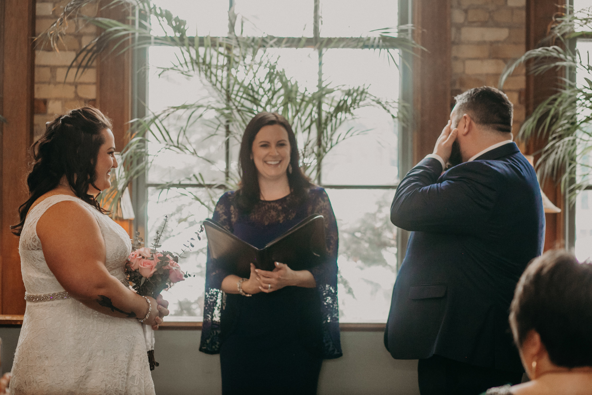 A groom cries seeing his bride for the first time in an intimate non-traditional wedding ceremony at W.A. Frost in St Paul MN