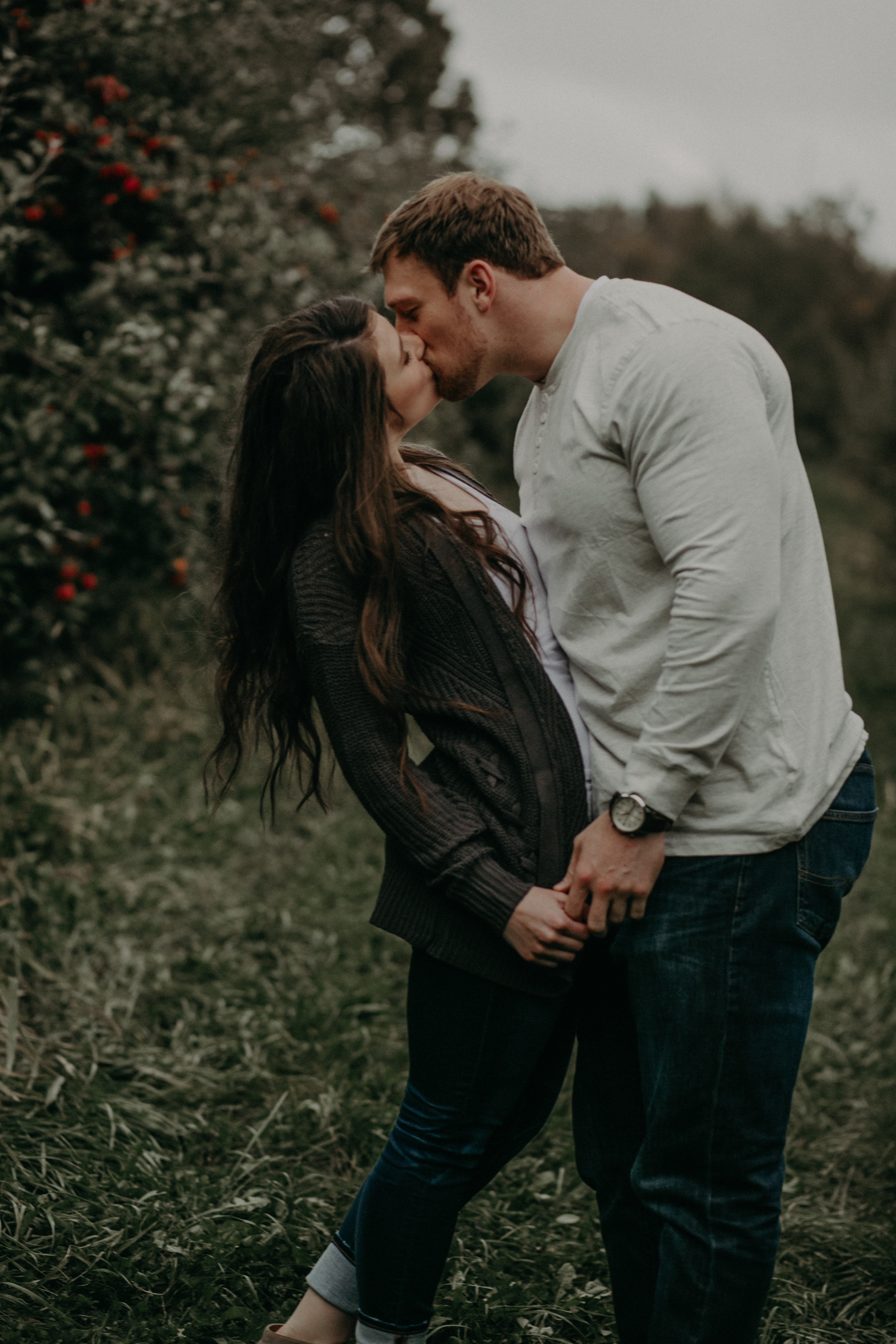 Kissing couple enjoys their engagement session in Hastings MN