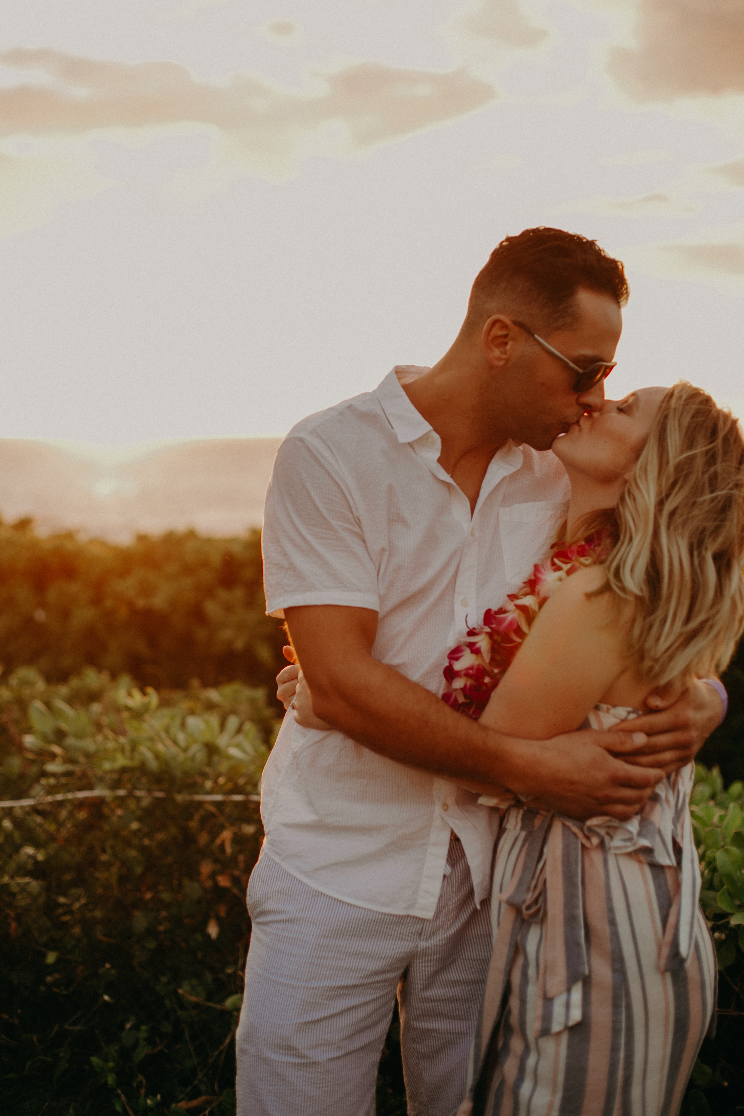 Andrea Wagner kisses her husband at sunset at Grand Wailea Waldorf Astoria resort on Maui, Hawaii