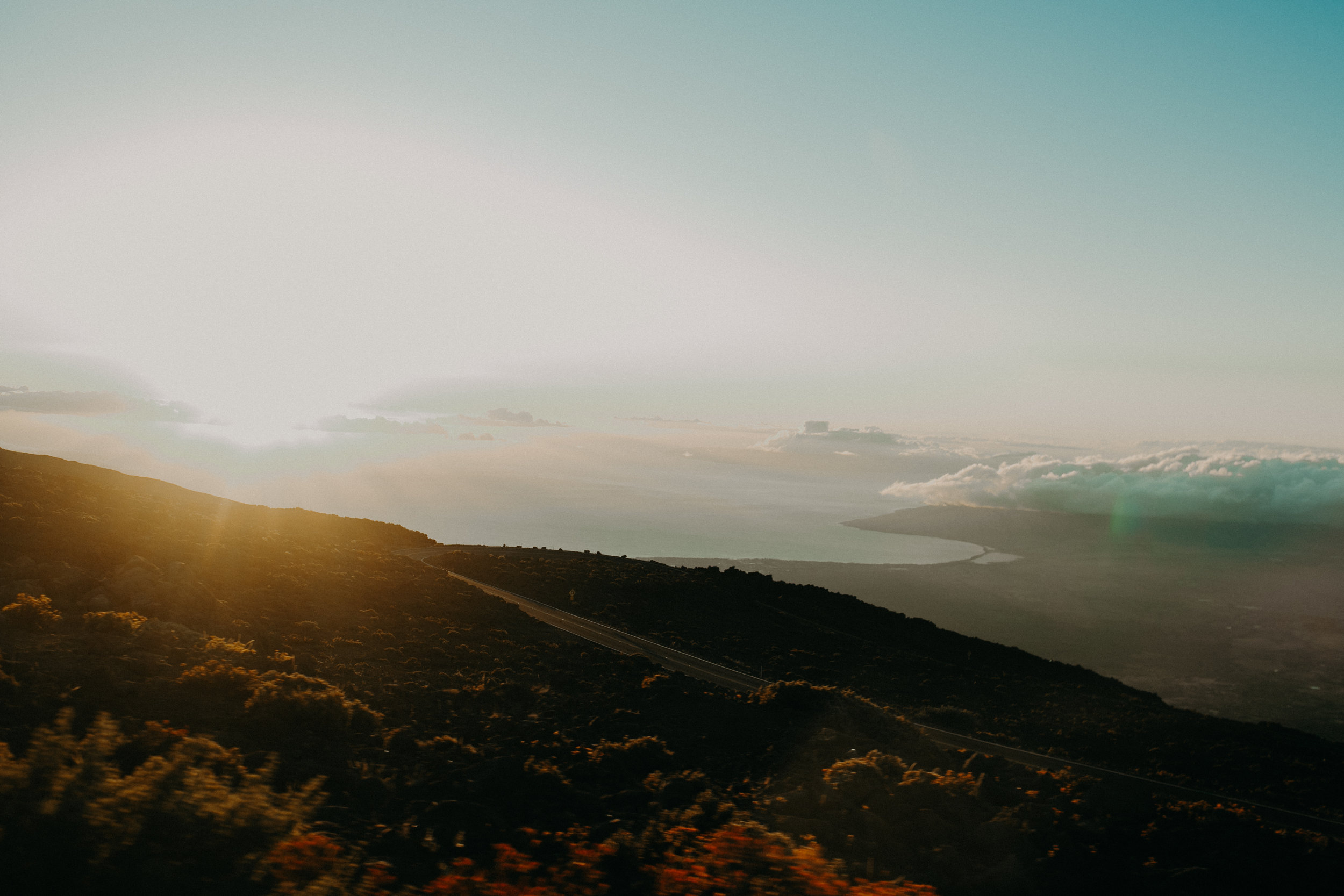 The sun sets from Haleakala Volcano over the north shore of Maui Hawaii 