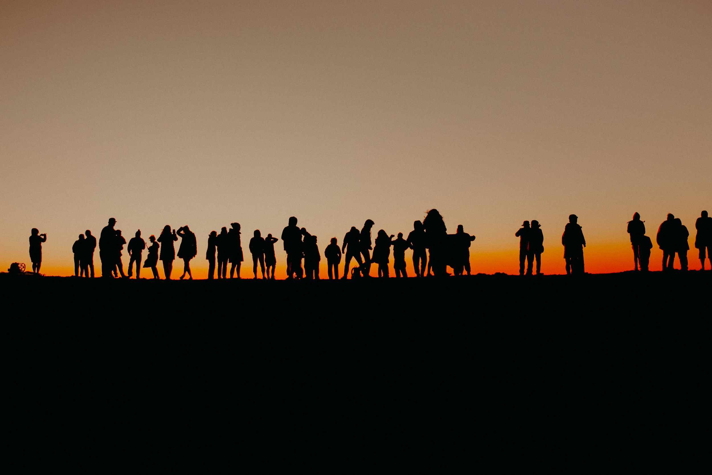  a row of people taking photos of the sun set from Haleakala Volcano in Maui Hawaii 