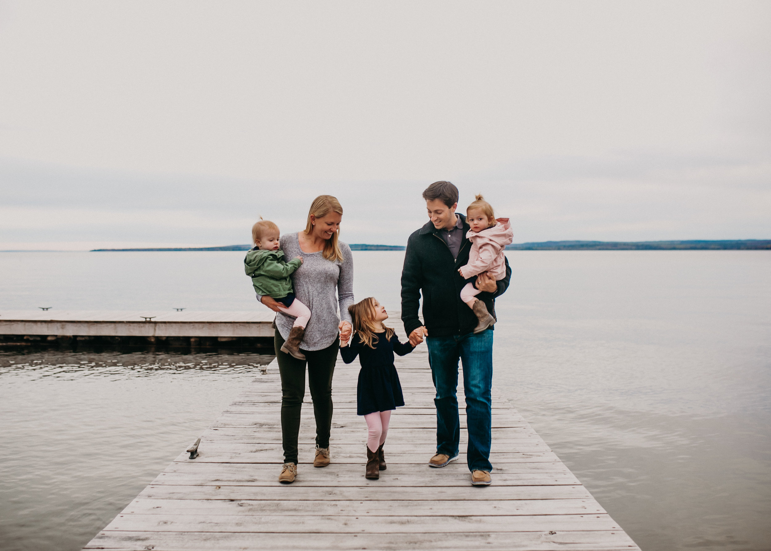  gorgeous family photo on a dock on Madeline Island during a lifestyle photo shoot with Andrea Wagner Photography 