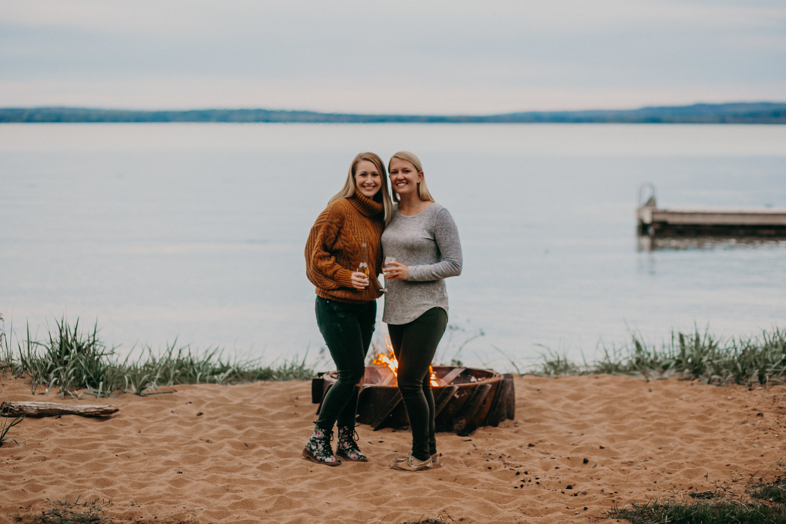  friends hanging on the beach with a campfire on Madeline Island 