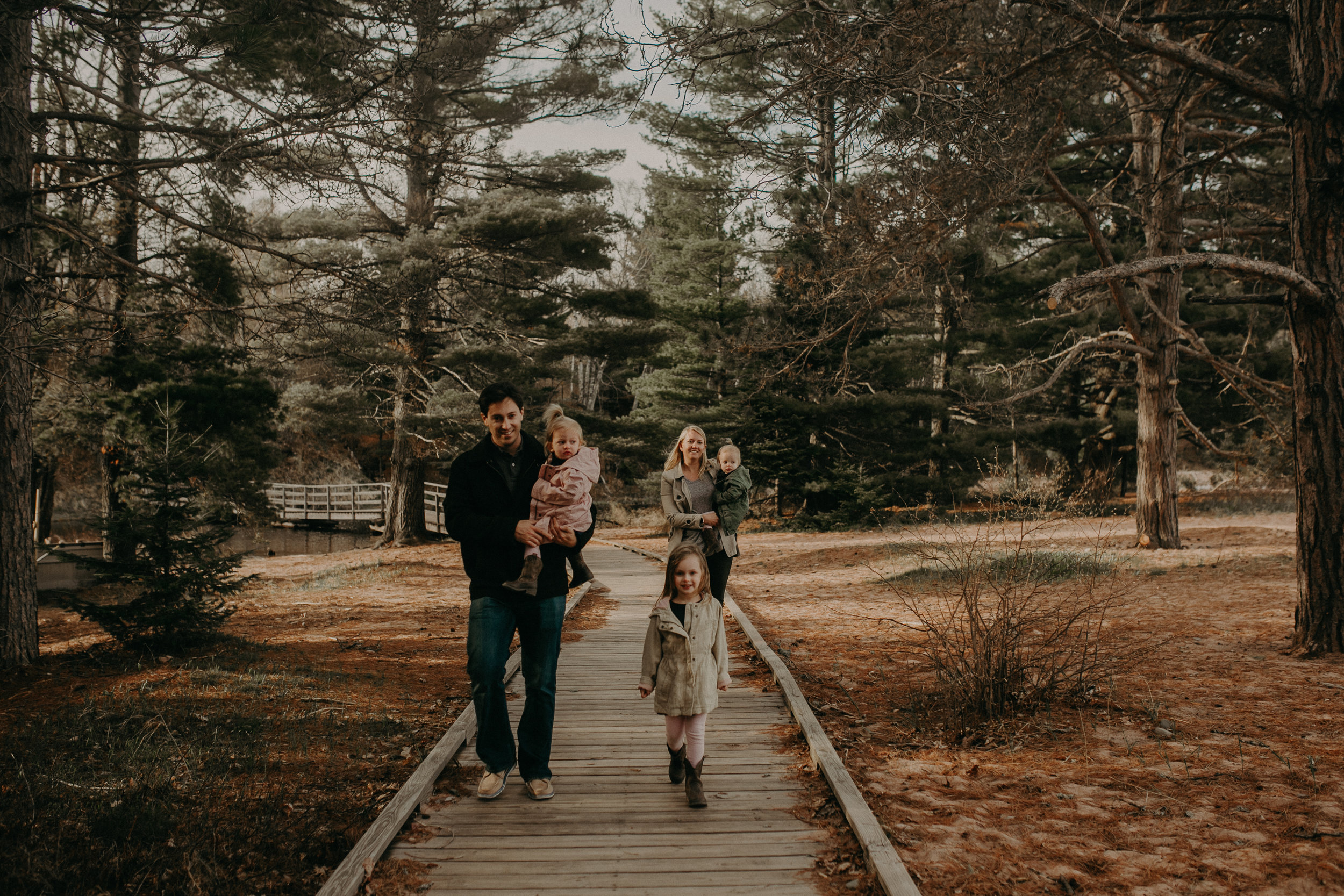  family walking through Big Bay Town Park on Madeline Island for a family photo shoot 