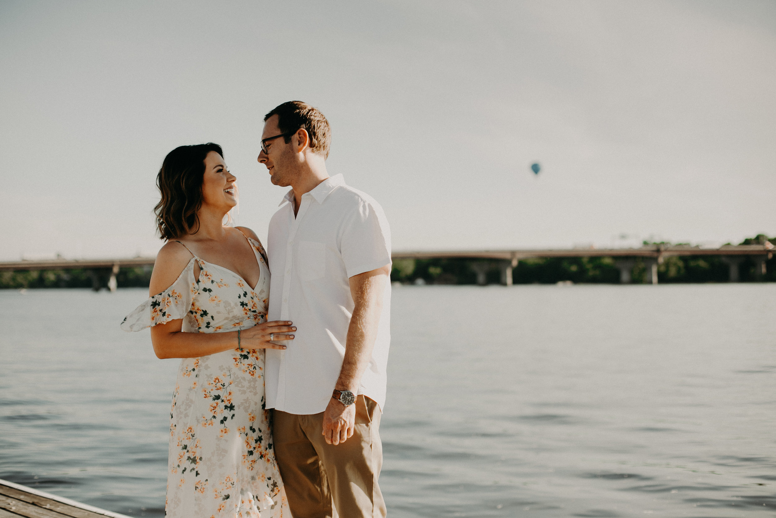  a hot air balloon makes an appearance at an engagement session in Hudson WI 