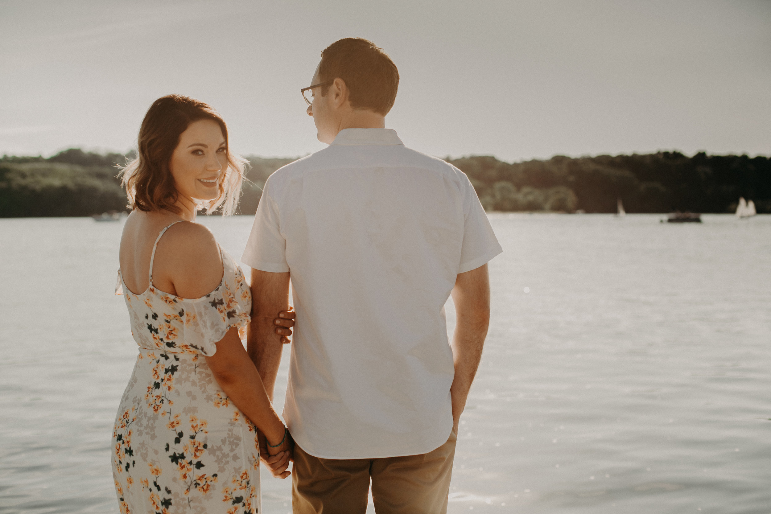  a beautiful couple poses for engagement pictures on the St Croix River in Hudson WI 