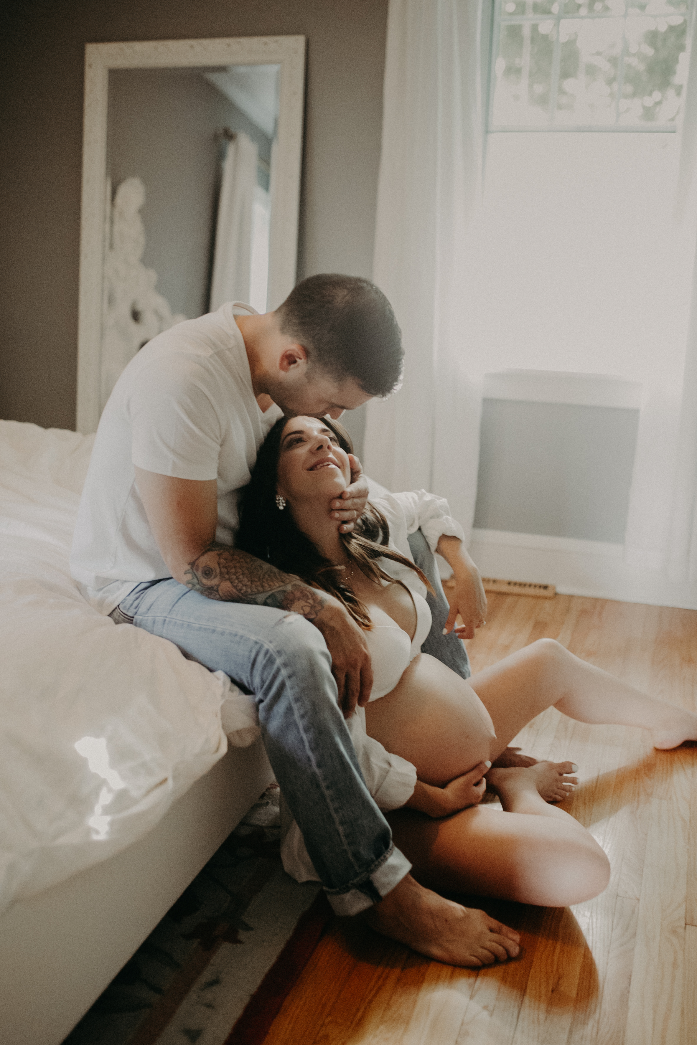  a loving couple cuddles with pregnant belly during maternity session in Minnesota 