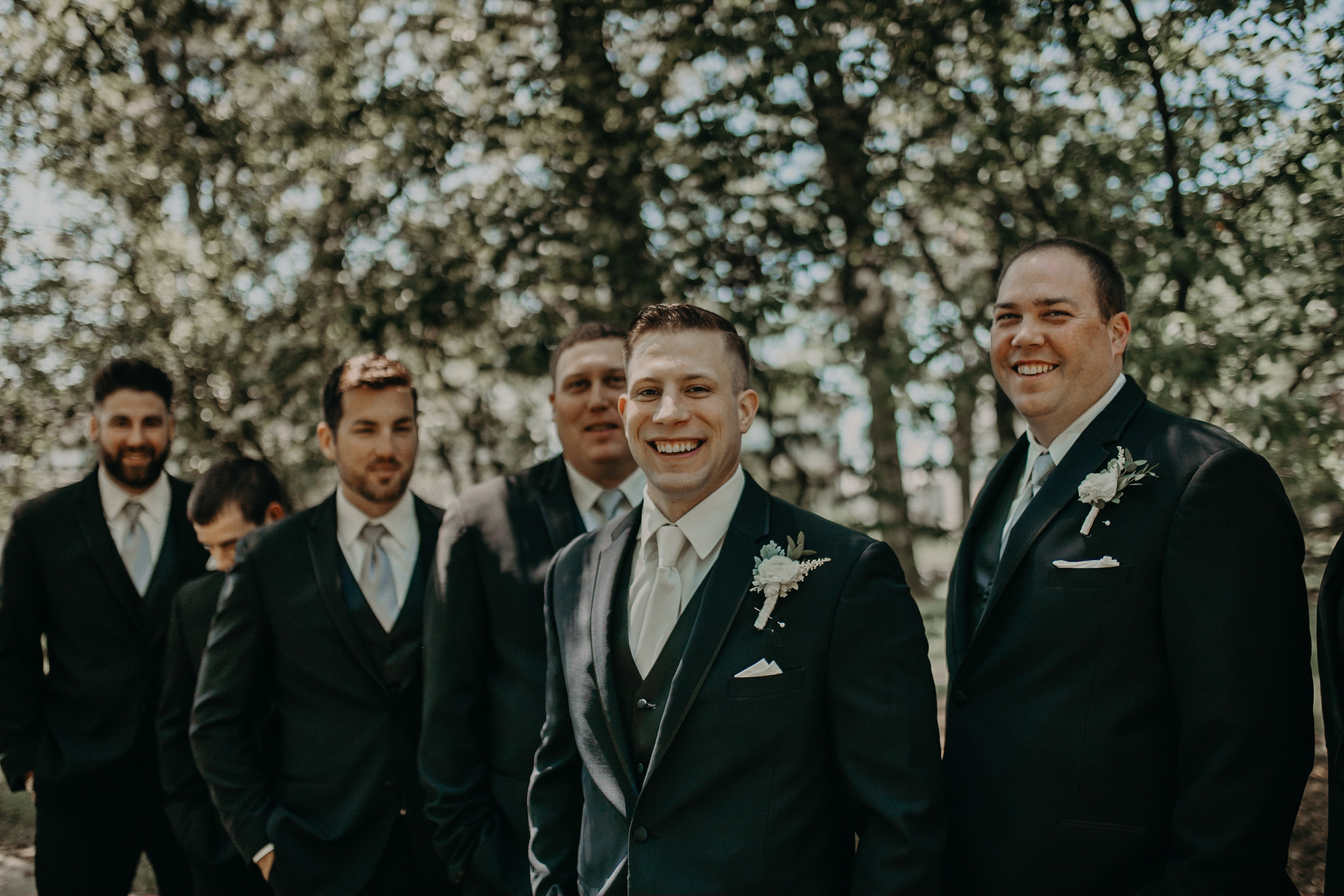  groom and his boys smile for group photos during his wedding at St Johns in Marshfield WI 