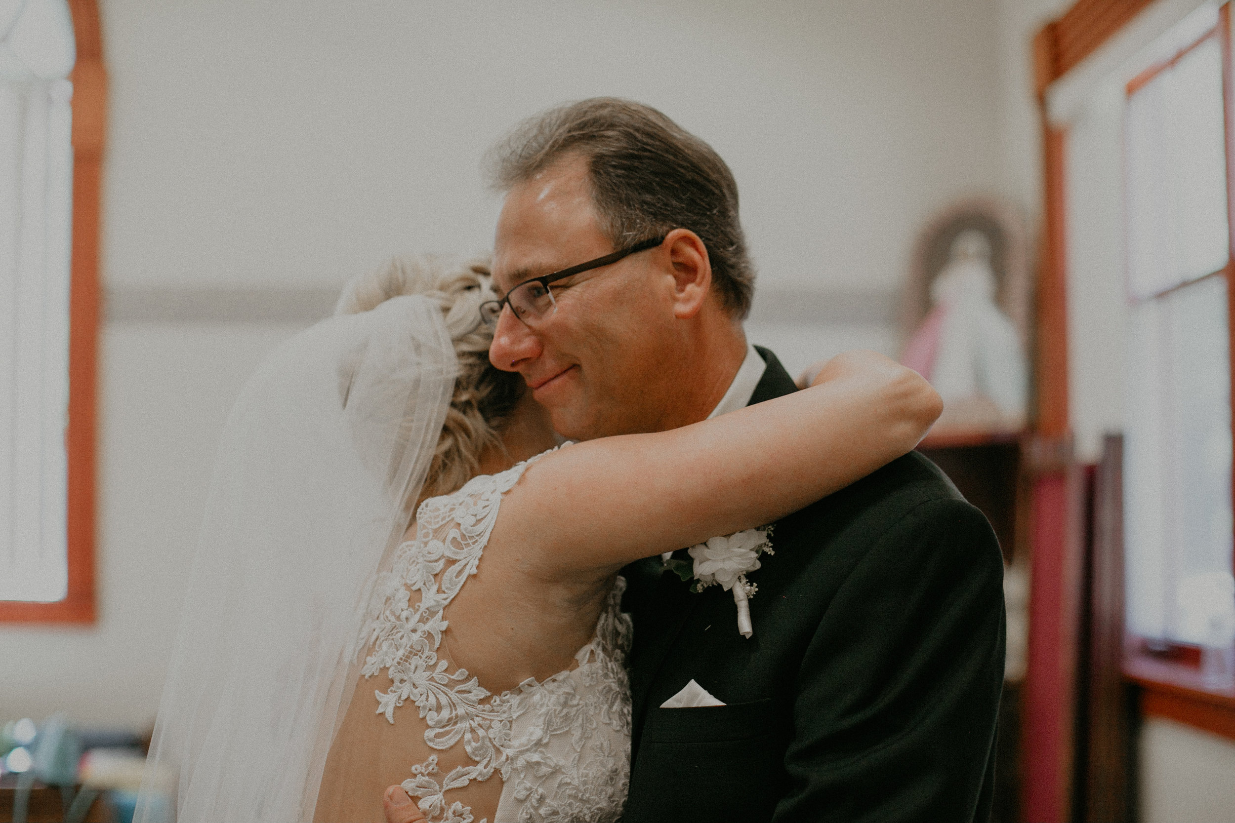  real and authentic moment of bride hugging her dad before her wedding in Marshfield WI 