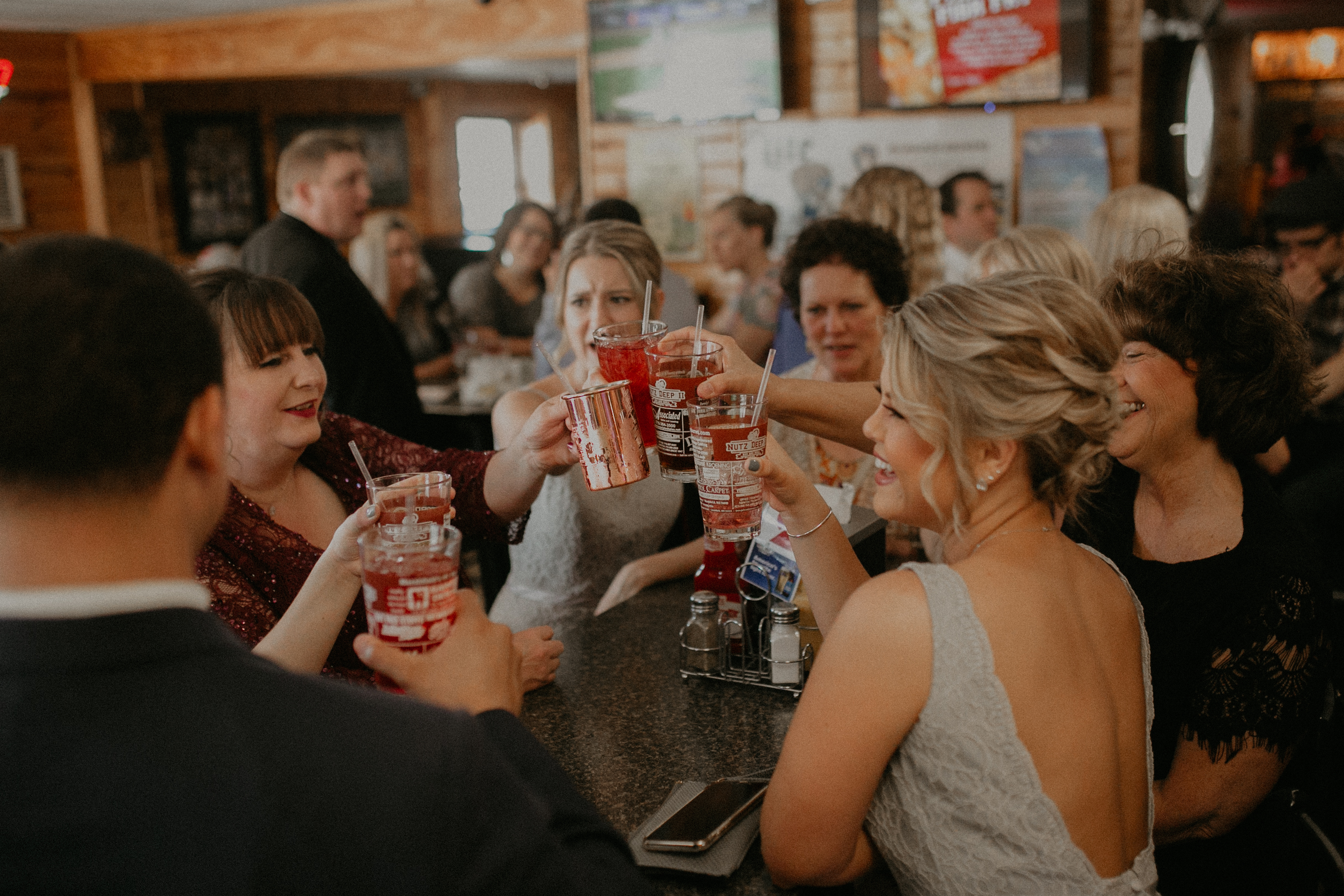 candid shot of wedding party toasting at Nutz Deep II in Marshfield WI