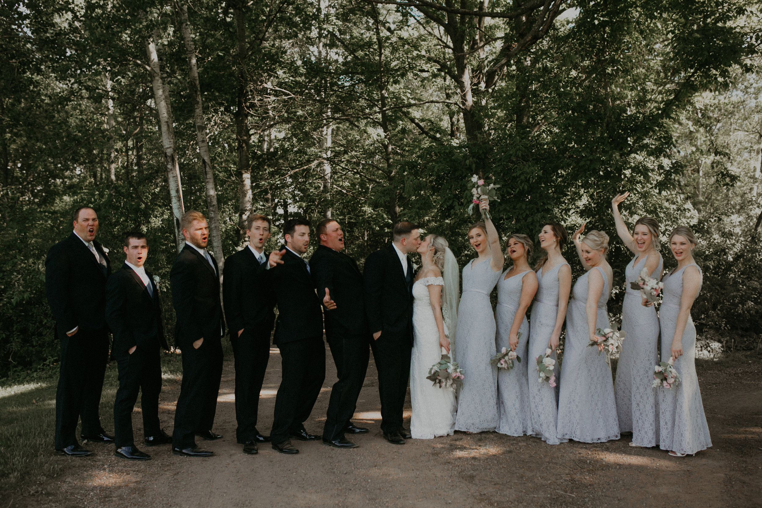  bridal party poses for photographs at RiversEdge Golf Course in Marshfield WI 