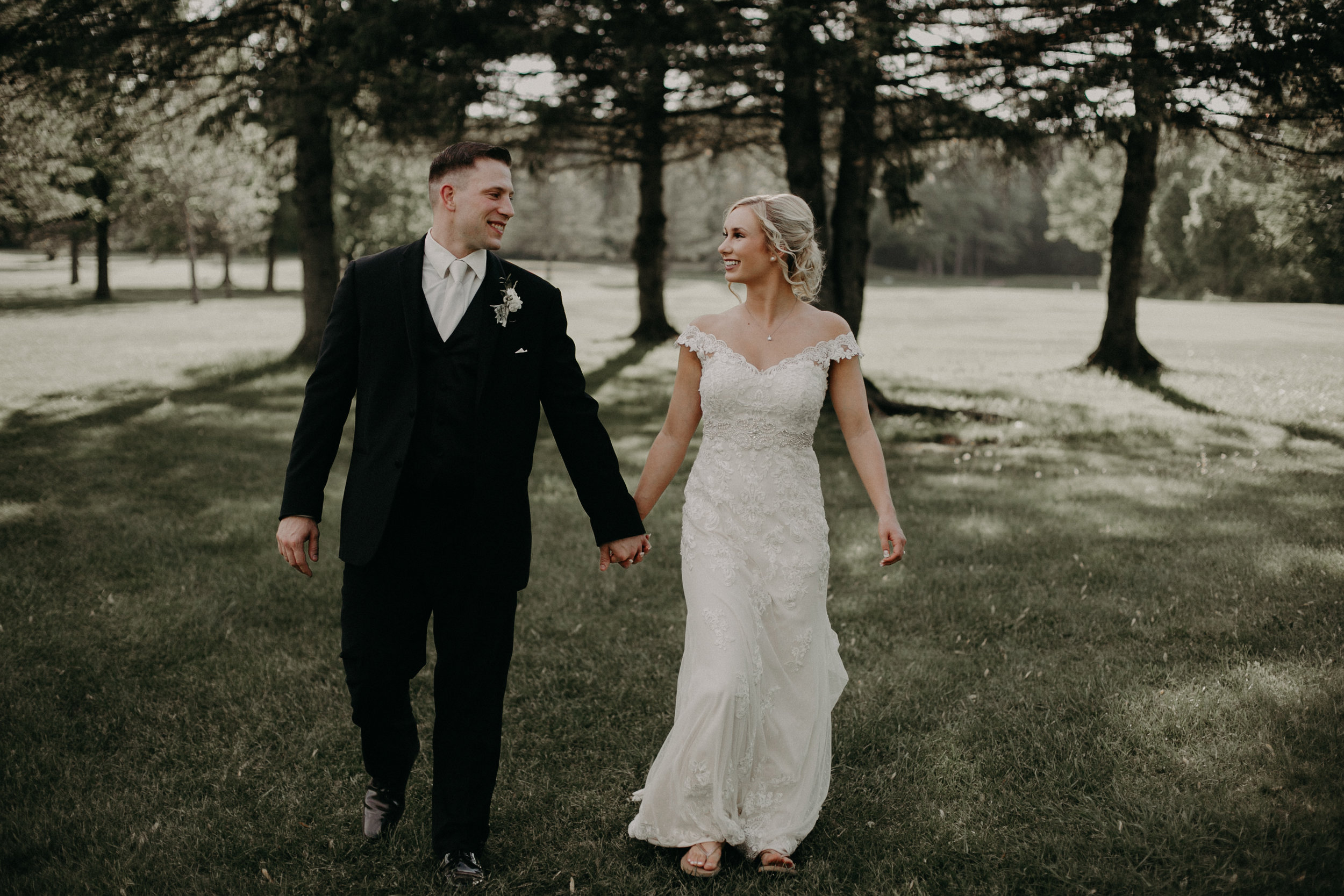  bride and groom portraits walking on the grounds at River Edge Golf Club in Marshfield WI 