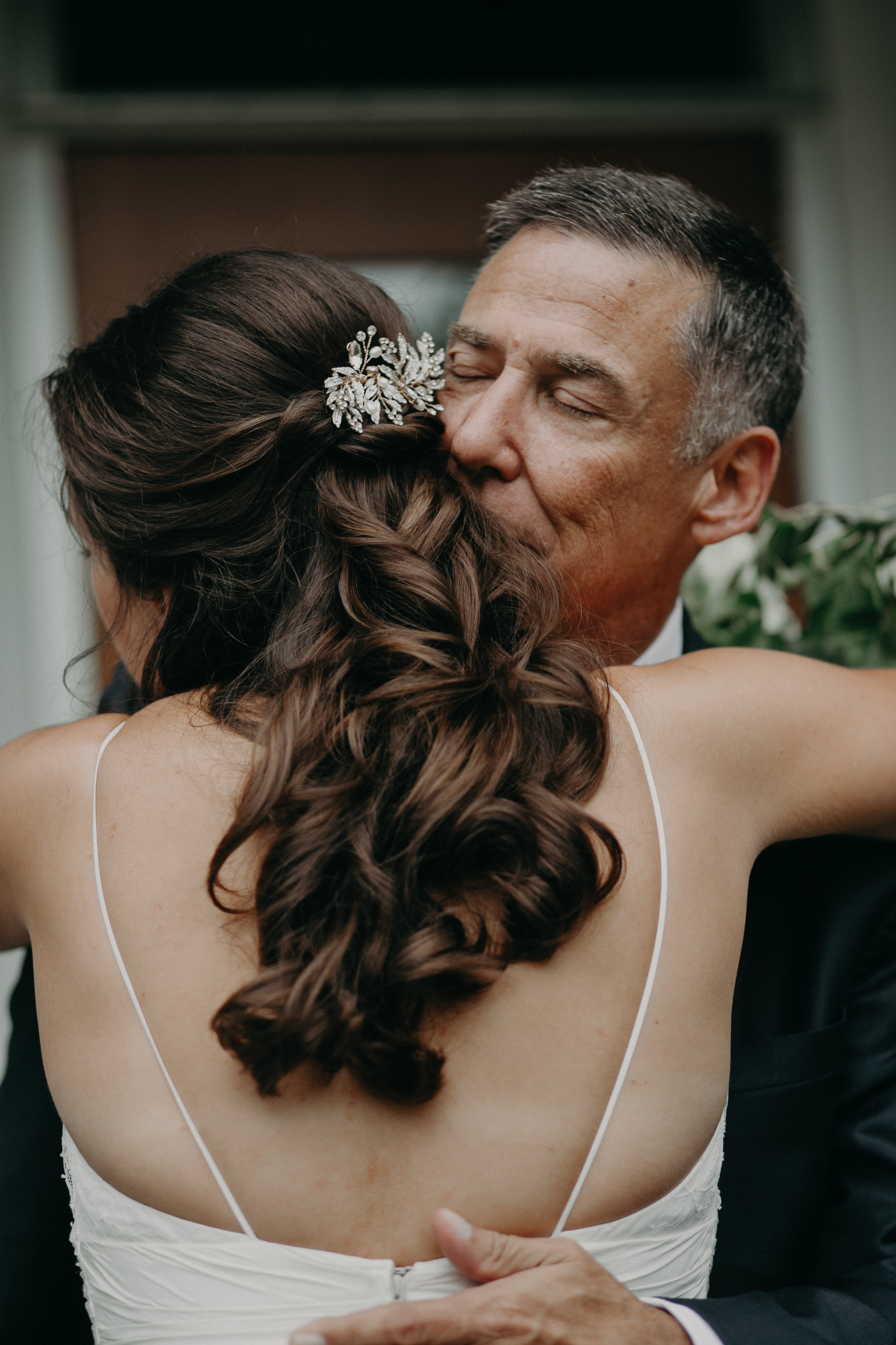 a Wayzata MN bride hugs her father while photographer Andrea Wagner captures intimate quiet moment