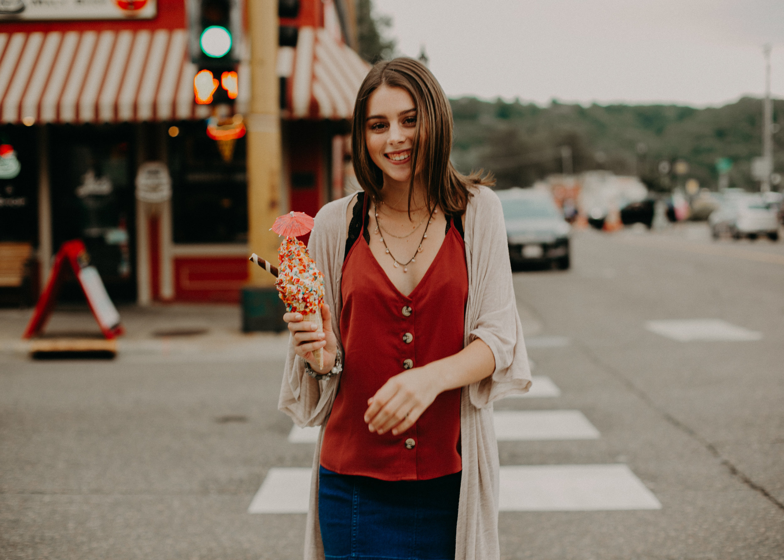  high school senior walks downtown Stillwater MN being candidly photographed by Andrea Wagner 