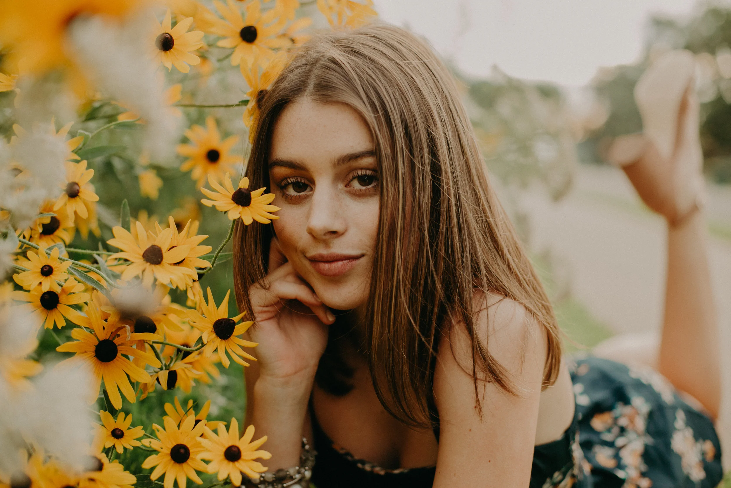 senior photography in a yellow flower field in Stillwater MN