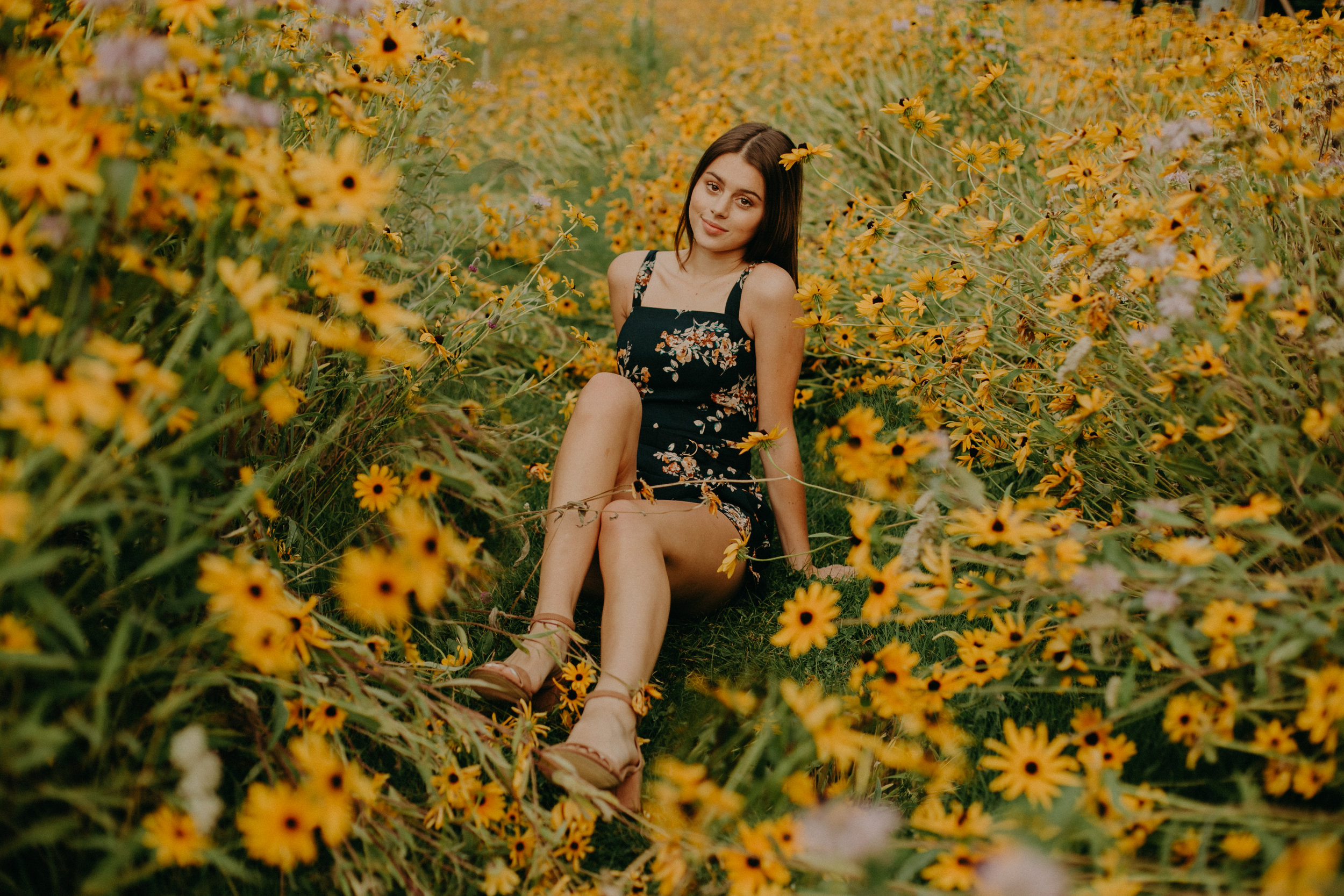  Andrea Wagner Photography captures epic moments in a bright yellow daisy field in Stillwater MN during senior photo shoot 