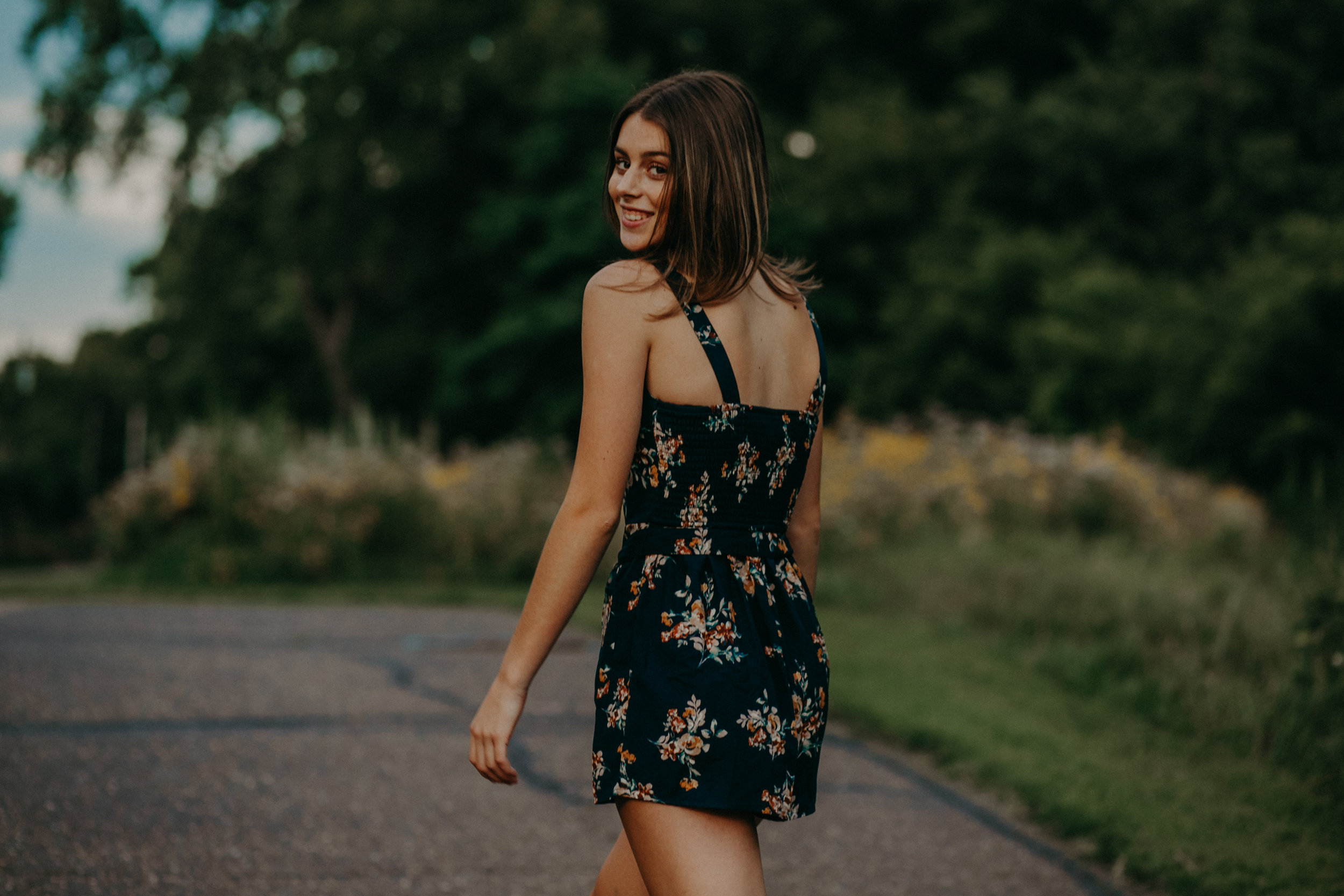  high school senior smiles during her photo shoot with Andrea Wagner 