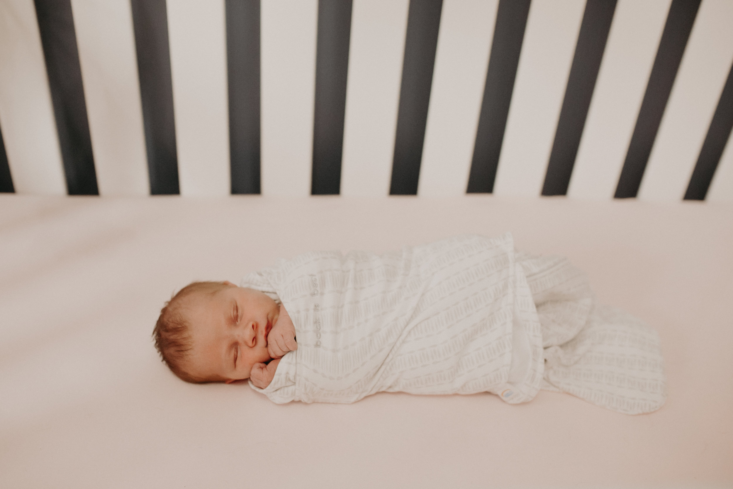  newborn lifestyle photographer in Eagan MN captures baby in her crib 