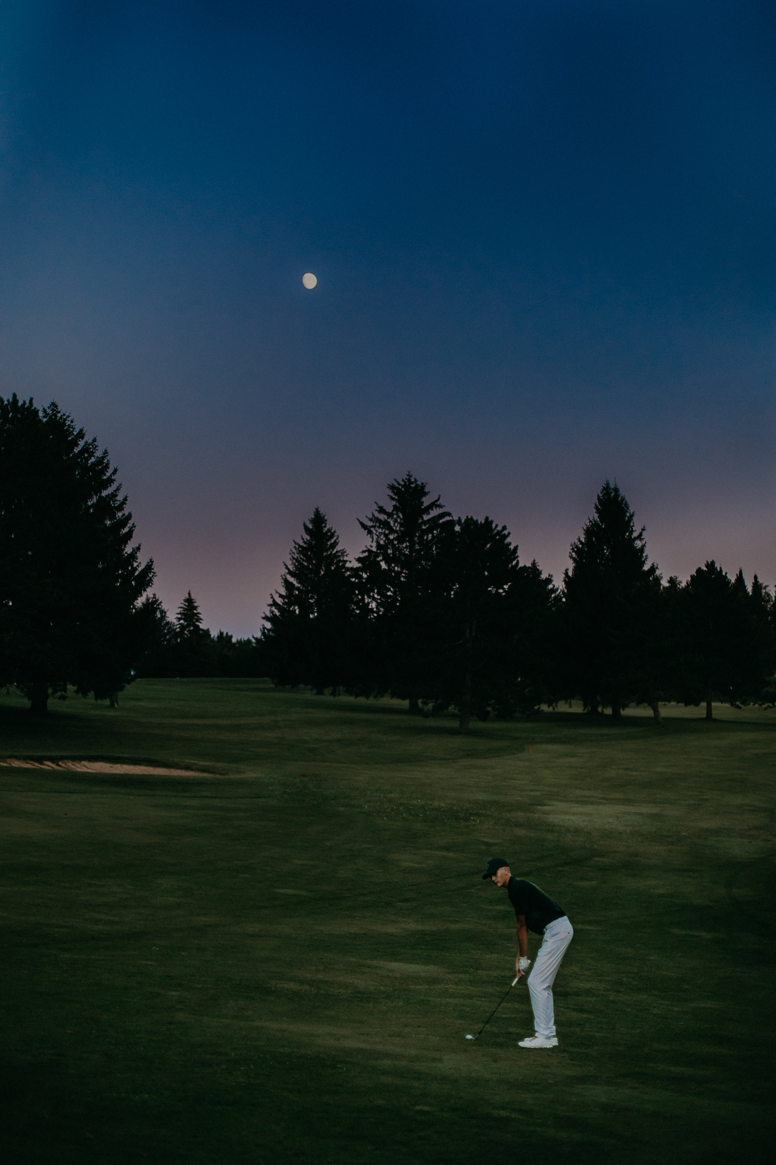 senior photo session on golf course in Spring Valley WI at full moon light