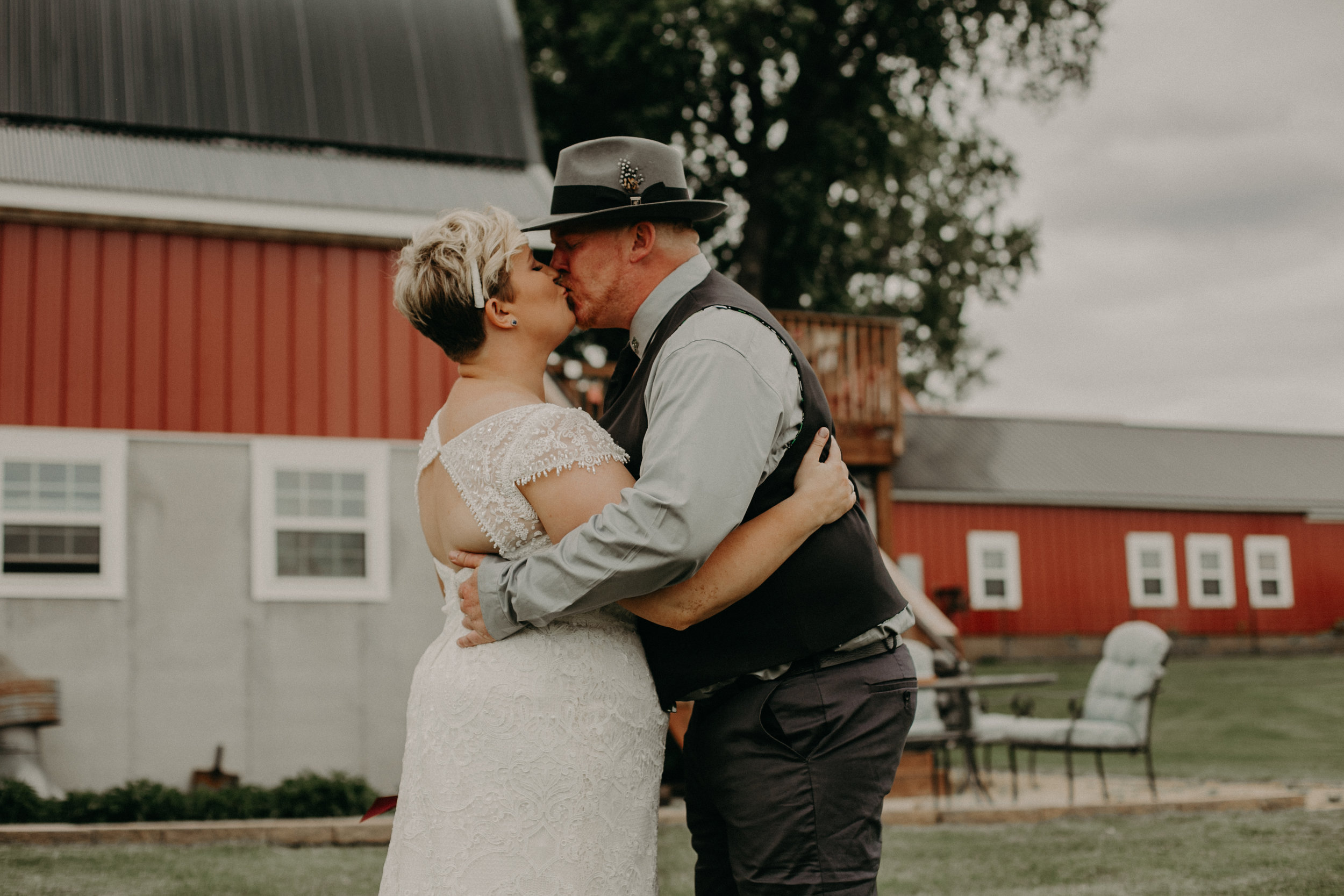  a couple kisses during their first look at their wedding in Ellsworth WI 