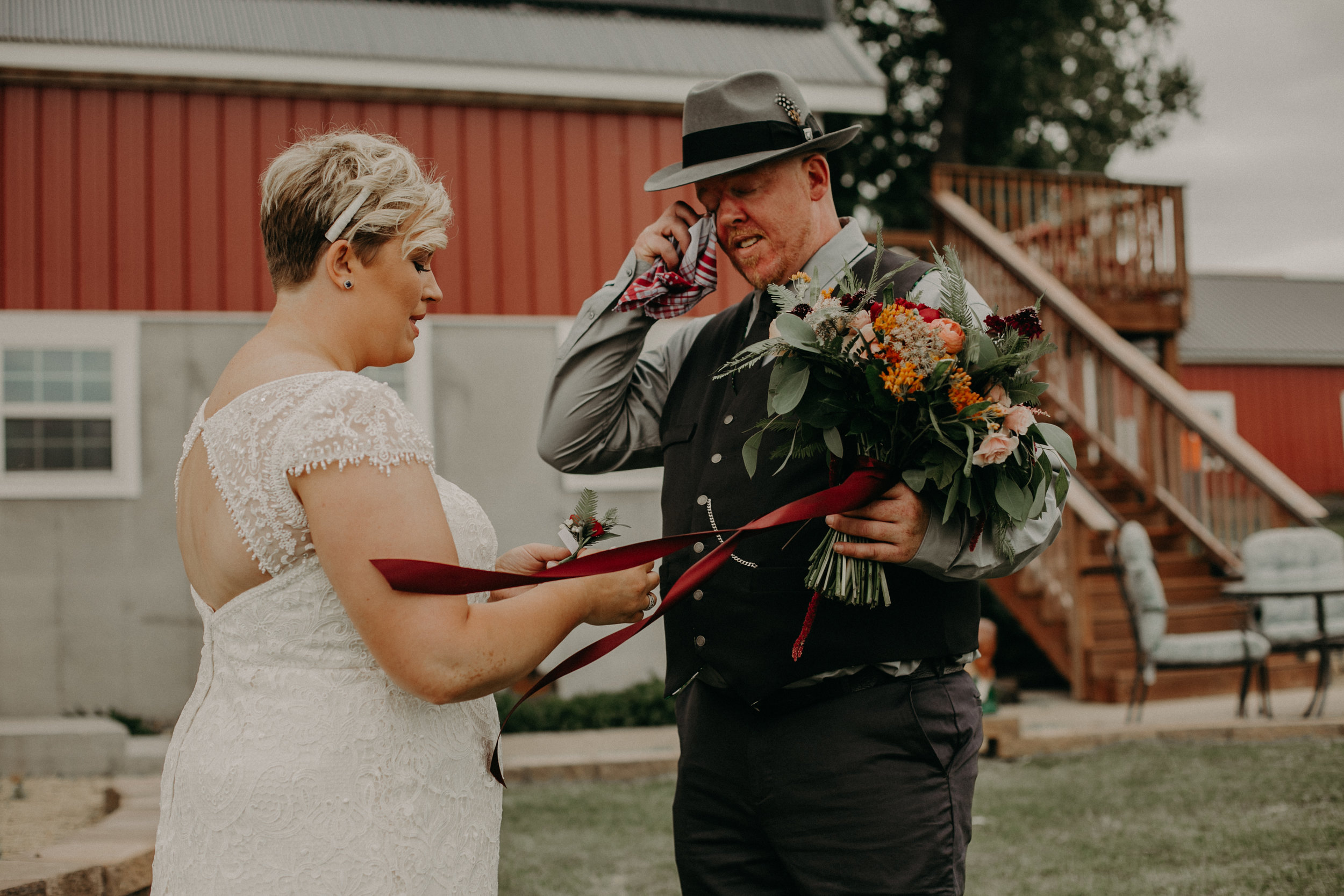  groom cries seeing his bride for the first time before their wedding at Jean Acres Barn in Ellsworth WI 