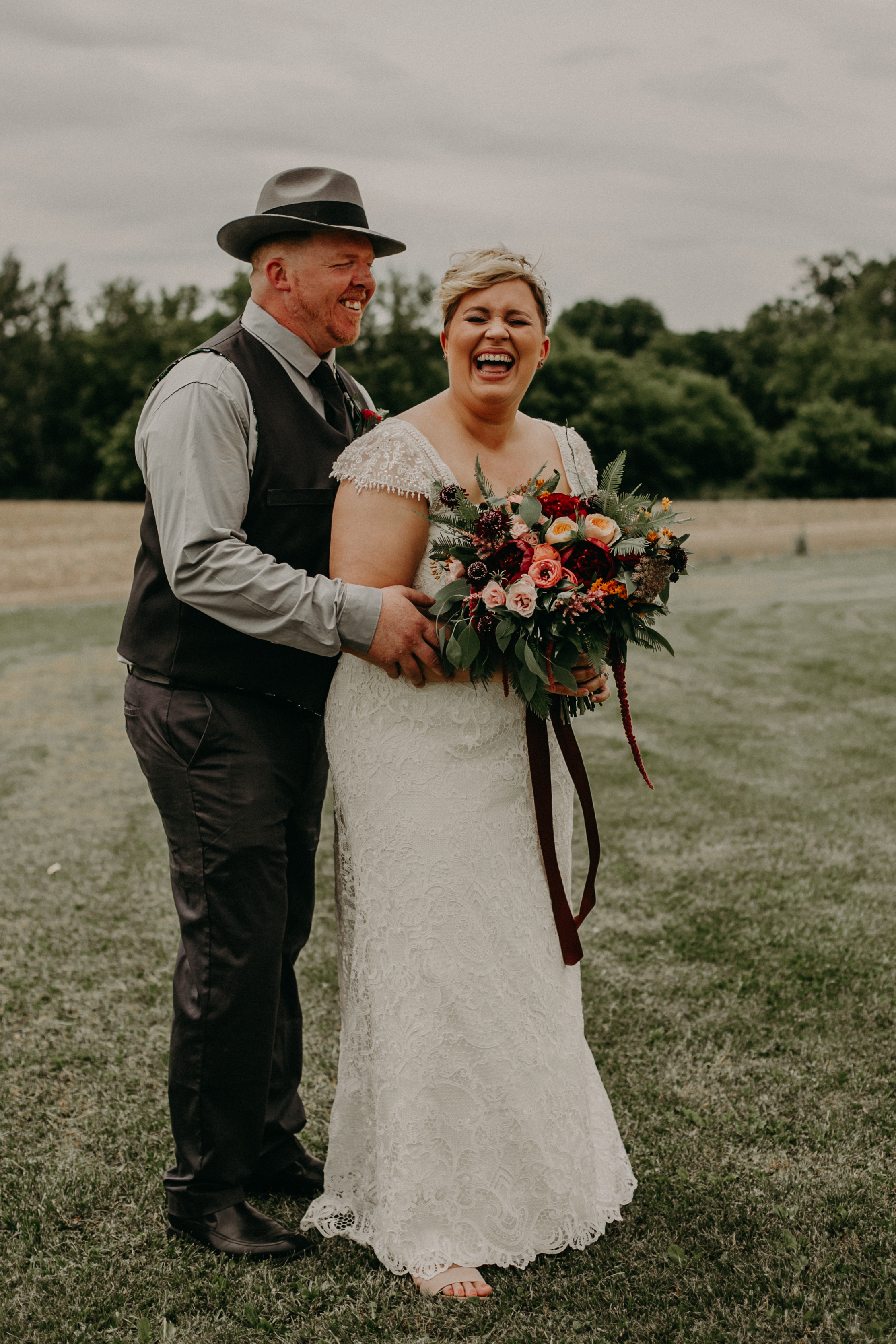  bride and groom laughing at their wedding at Jean Acres Barn in Ellsworth WI 