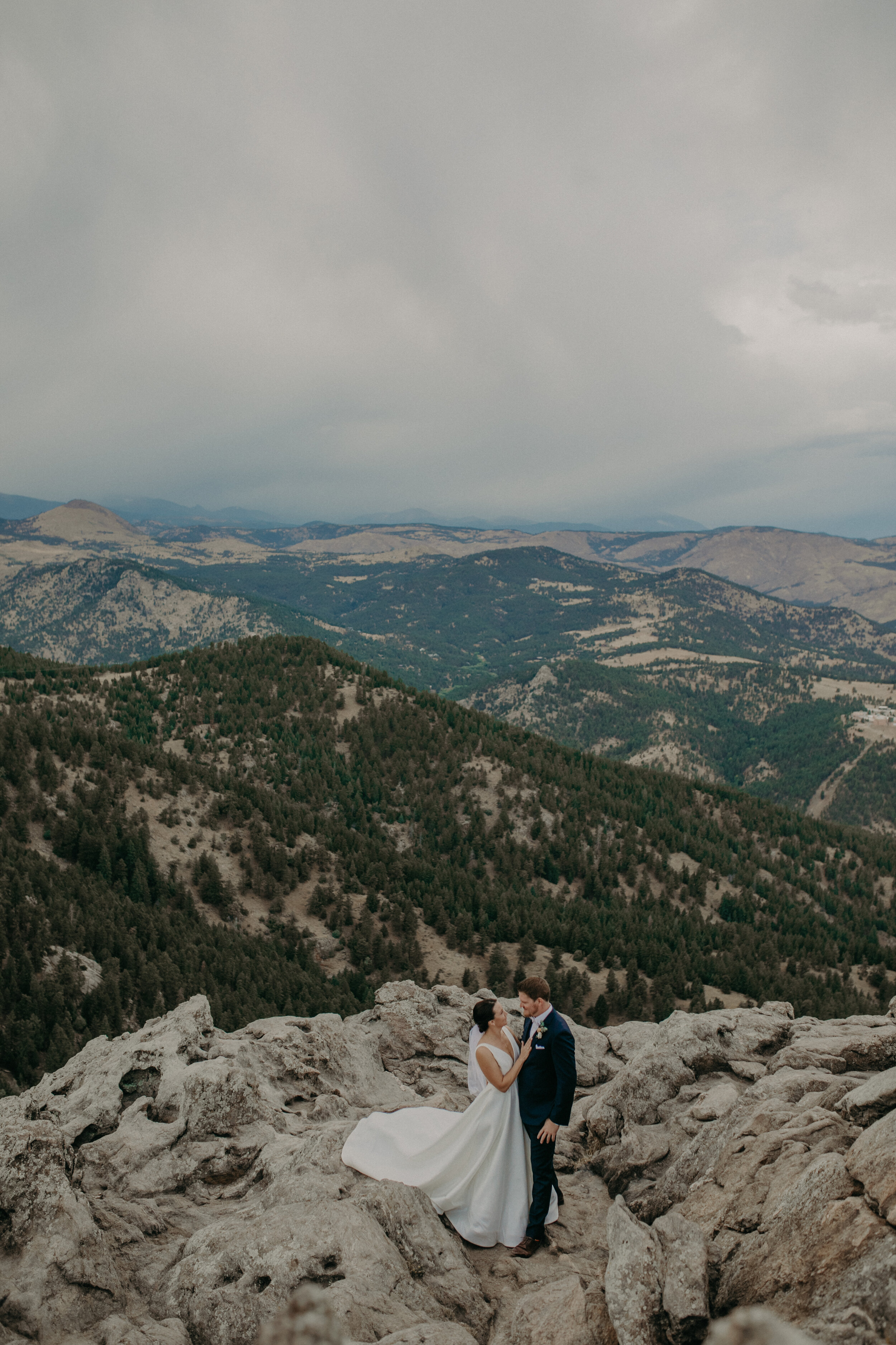 Andrea Wagner photographs a bride and groom on Flagstaff Mountain during elopement at Lost Gulch Lookout