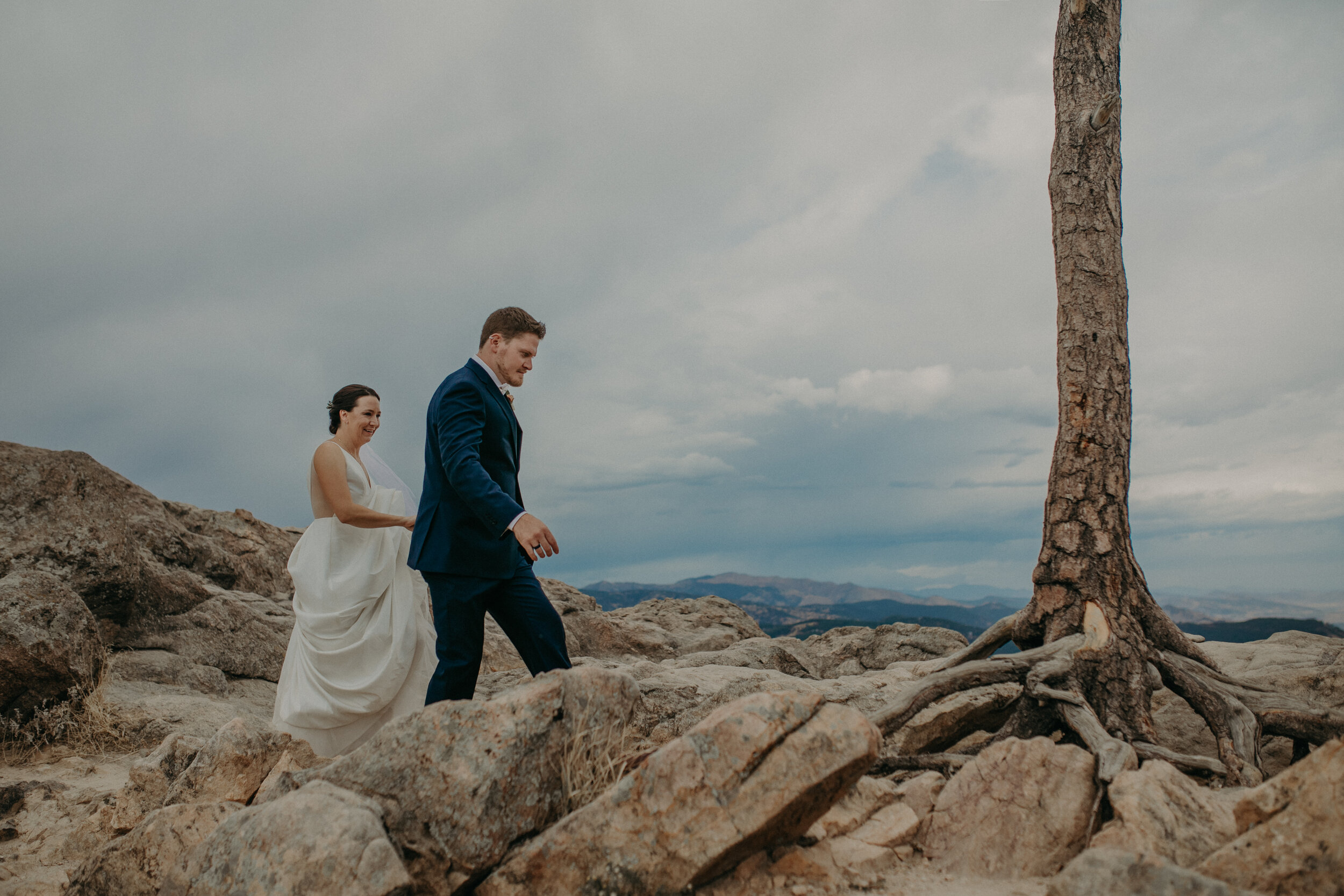  a couple climbs Lost Gulch after their wedding in Boulder Colorado 