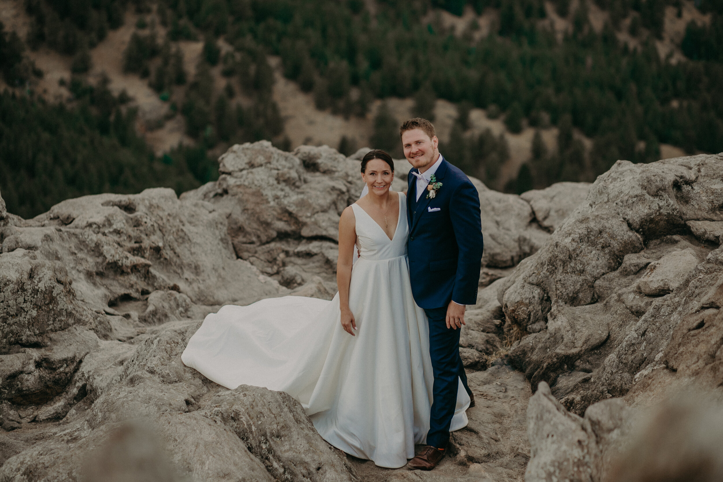  bride and groom pose on Lost Gulch Lookout after their fall wedding 