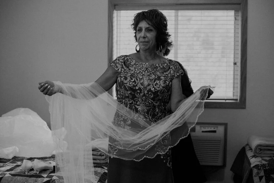 moody black and white image of bride getting ready at Pine Lake Camp in Waupaca WI