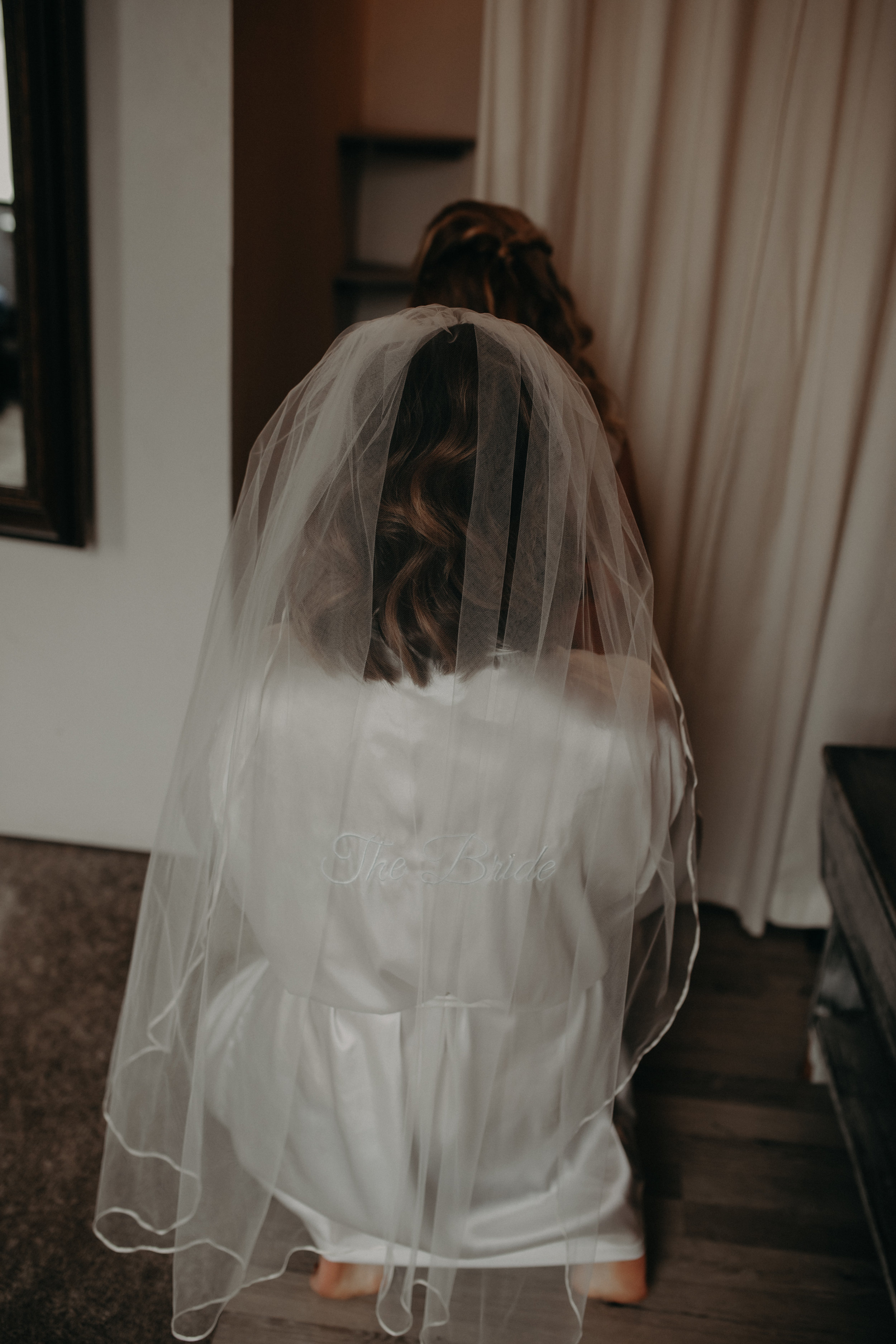 bride in robe with veil on gets ready at The Loft at Studio J in Stillwater MN