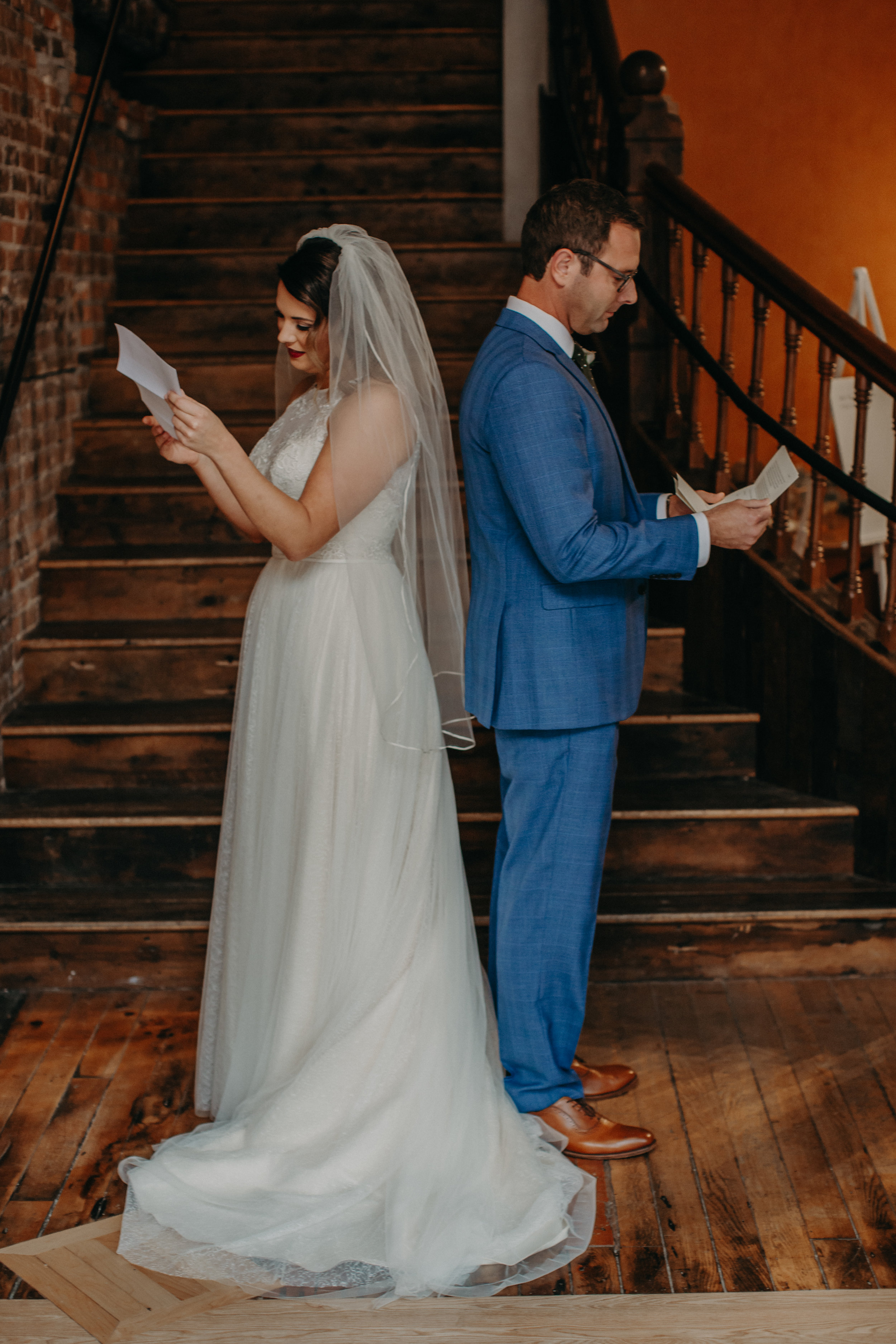 a Stillwater Mn bride and groom read intimate letters before their first look at The Loft at Studio J
