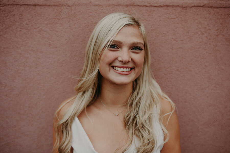  pink wall in downtown Hudson is perfect backdrop for senior photos 