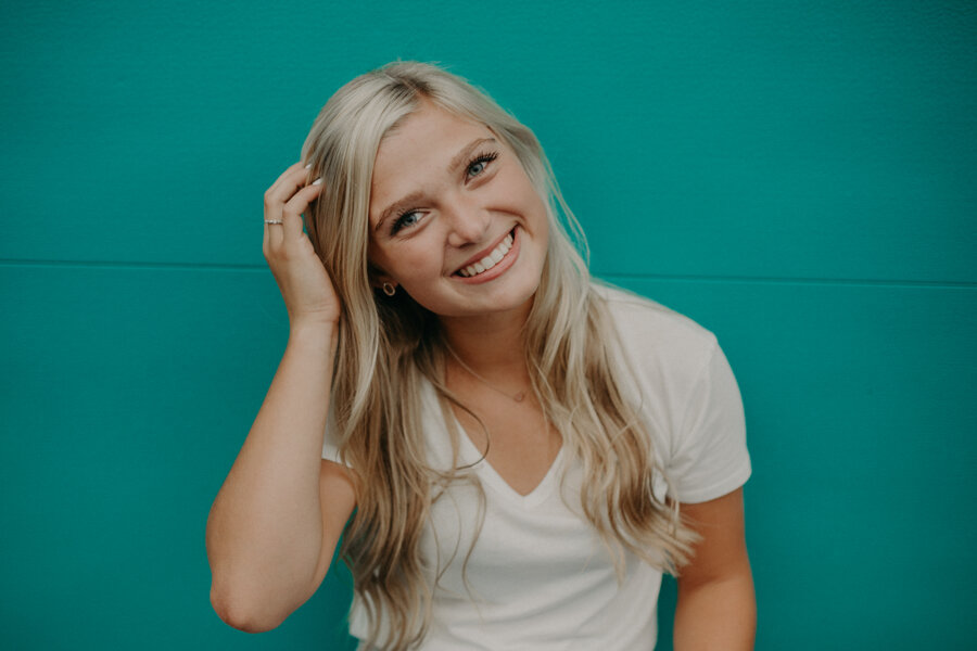  teal wall in Hudson WI provides a great backdrop for senior portraits 