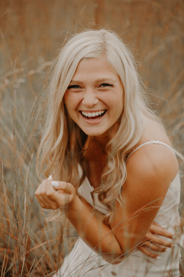  Ellie Rieper laughs during her senior photoshoot in Hudson WI with Andrea Wagner 