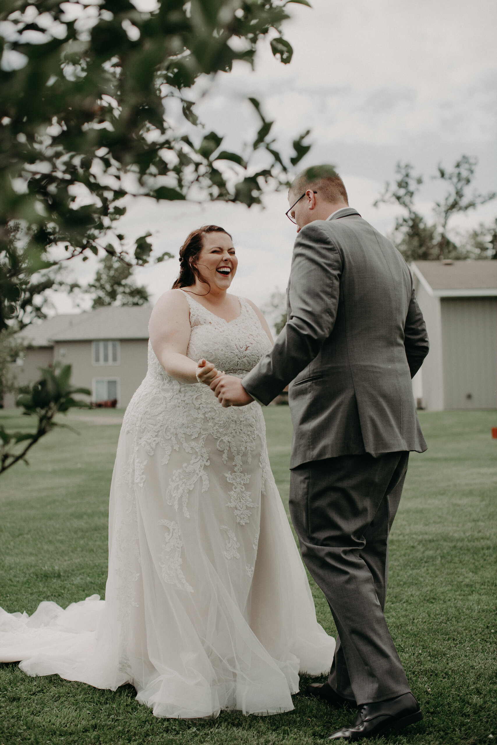  bride laughs during her first look with her groom in Clayton WI capture by Andrea Wagner 