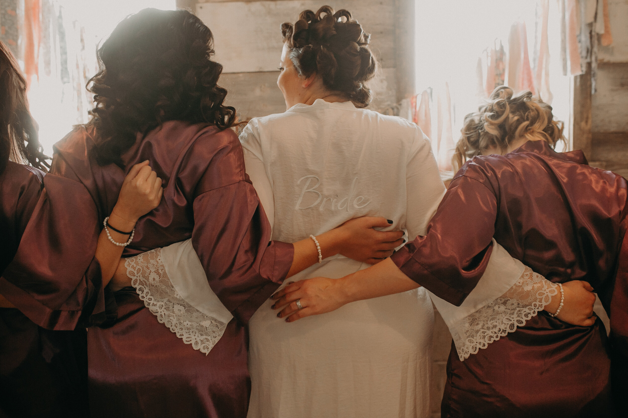  wedding photographer near Clayton WI captures bride with her bridesmaids at The Mumm Barn 