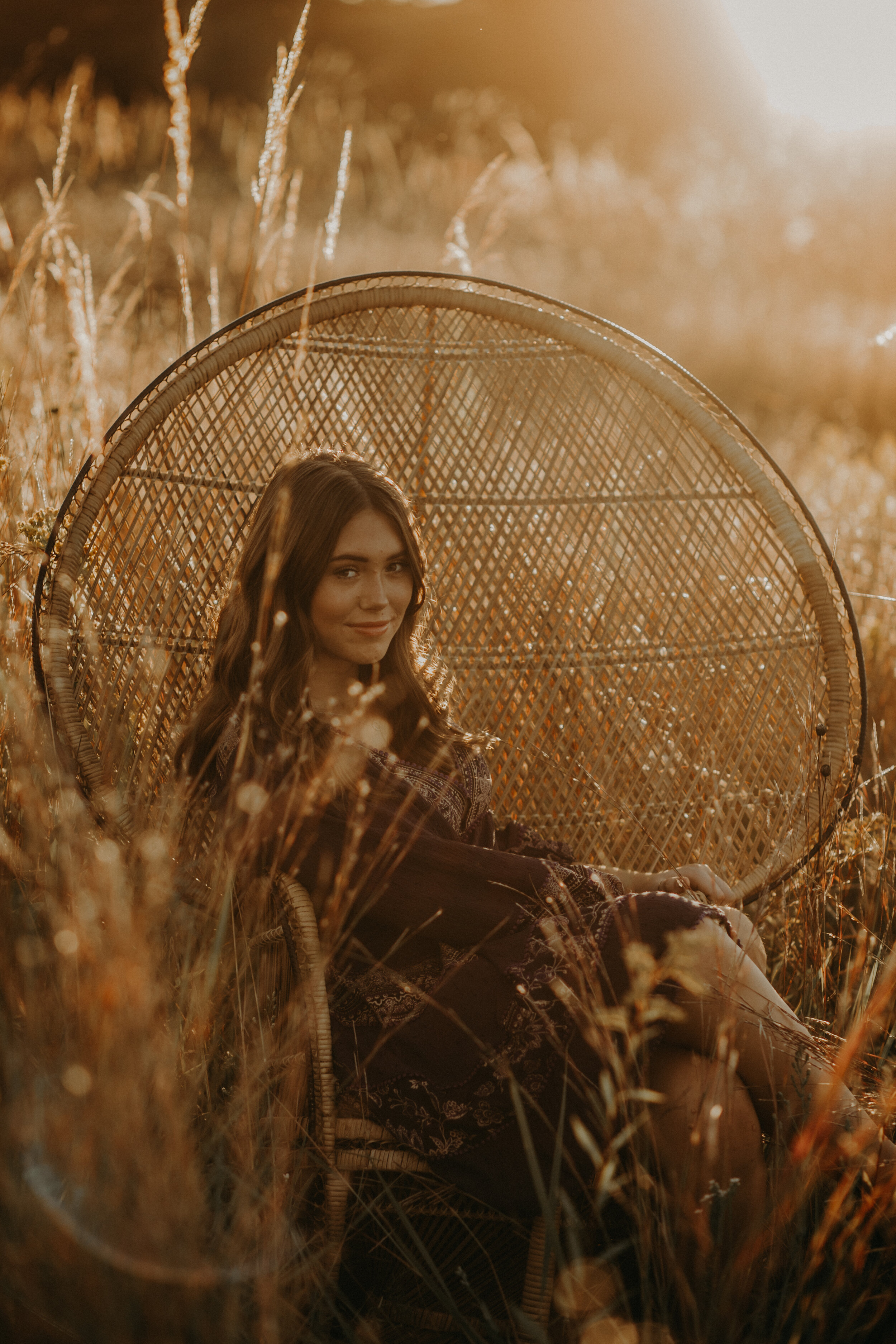  Hudson WI senior photos with peacock chair in flower field at sunset with Andrea Wagner Photography 