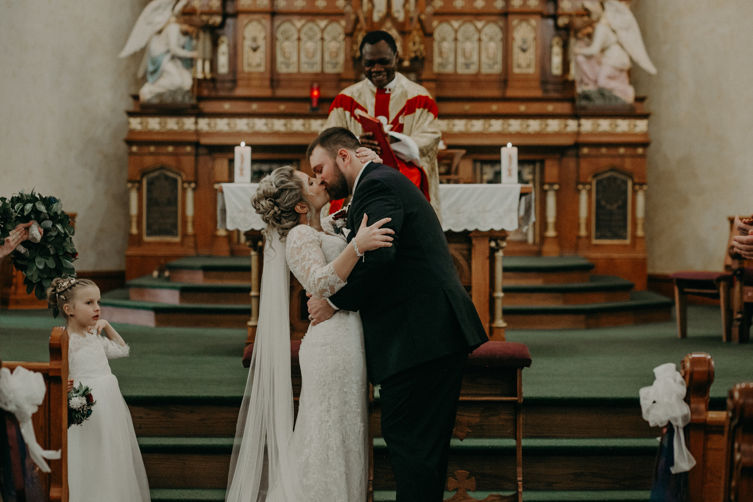  Andrea Wanger Photography cozy winter Wisconsin wedding. Perfect Wisconsin wedding in February. Elegant winter wedding church ceremony. First kiss. 