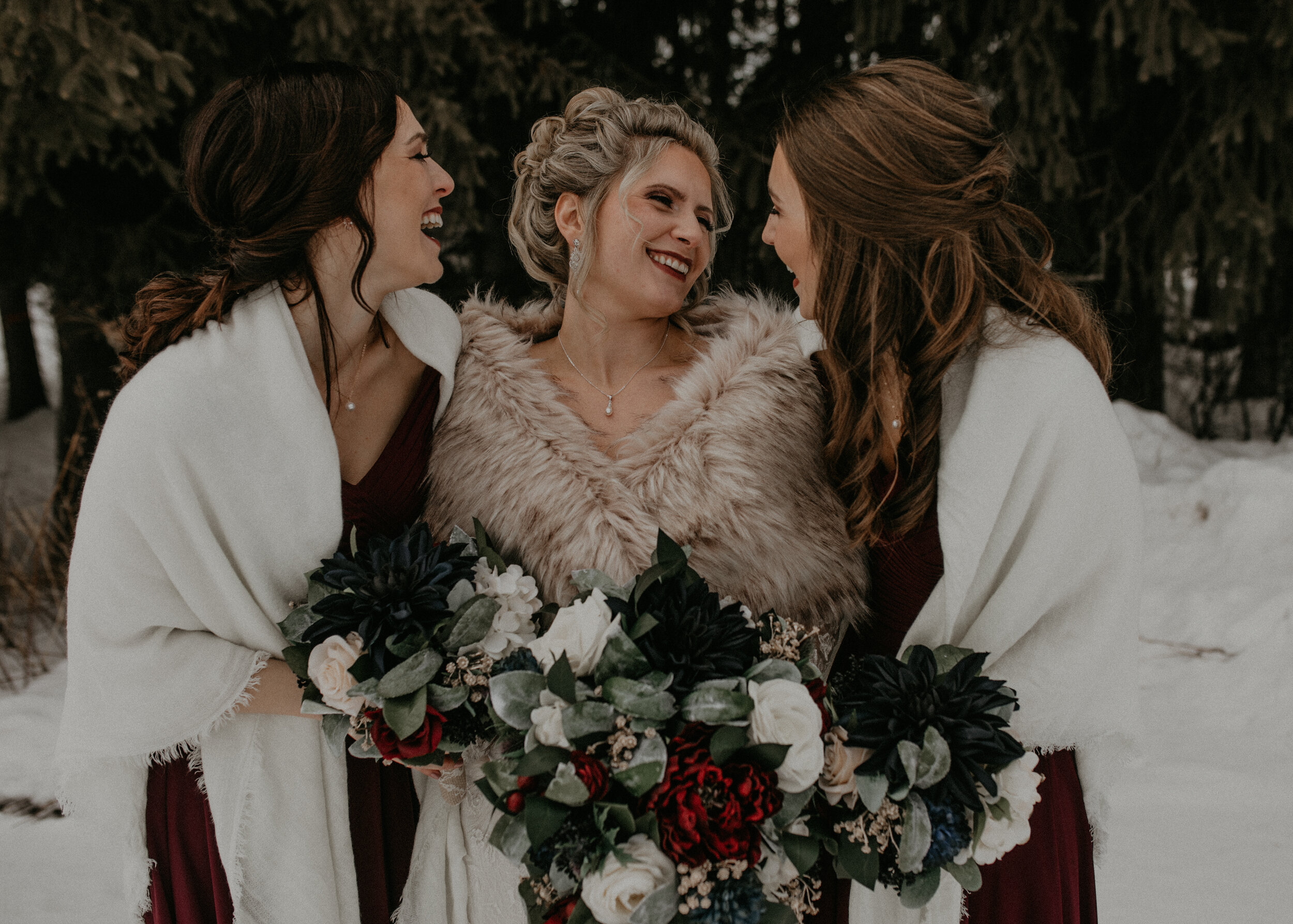  Andrea Wanger Photography cozy winter Wisconsin wedding. Perfect Wisconsin wedding in February. Elegant winter wedding bride with bridesmaids outside in the snow. 